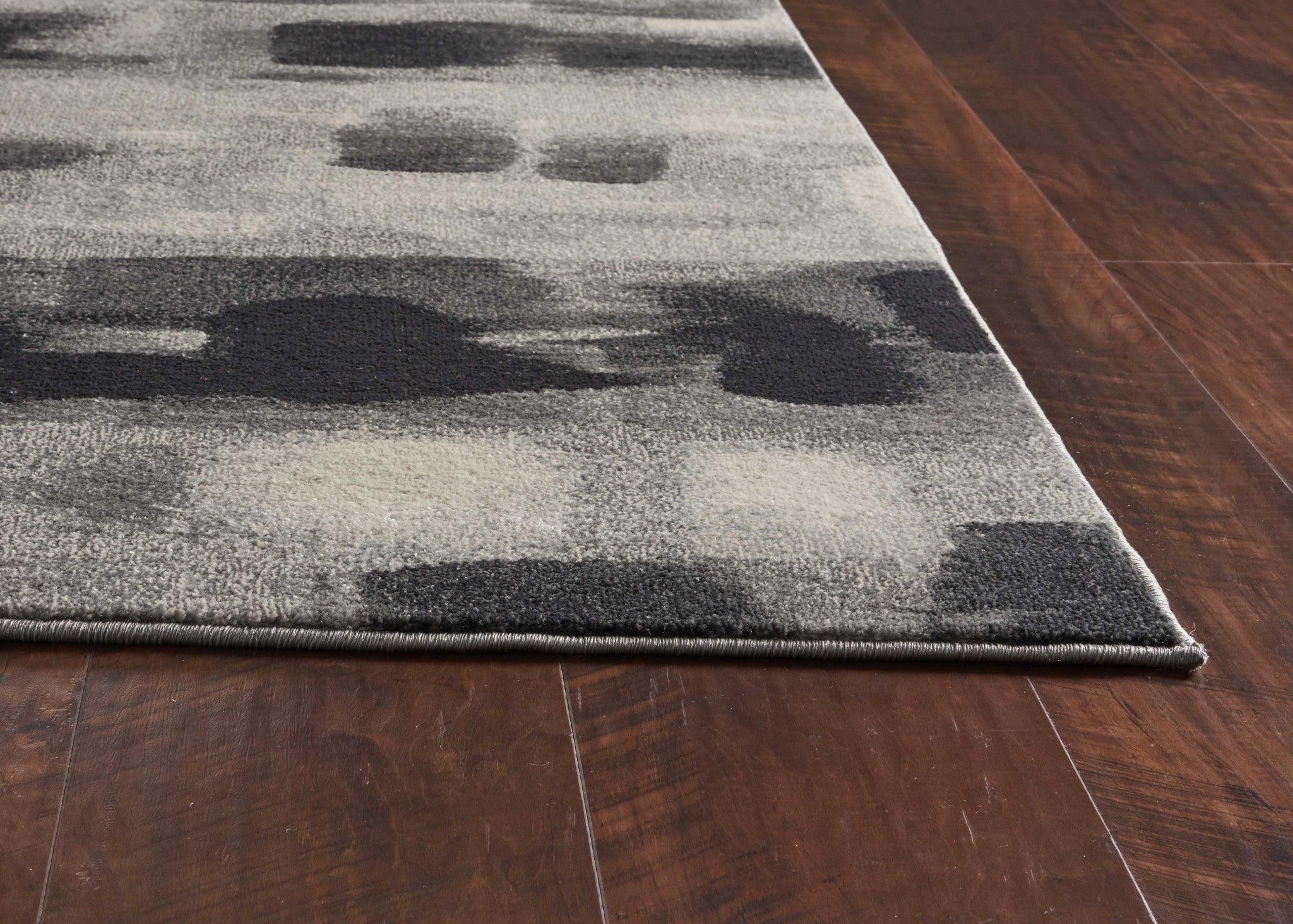 8x11 inches Shades of Grey Machine Woven Abstract Brushstroke rug showcasing a modern abstract design in grey tones.