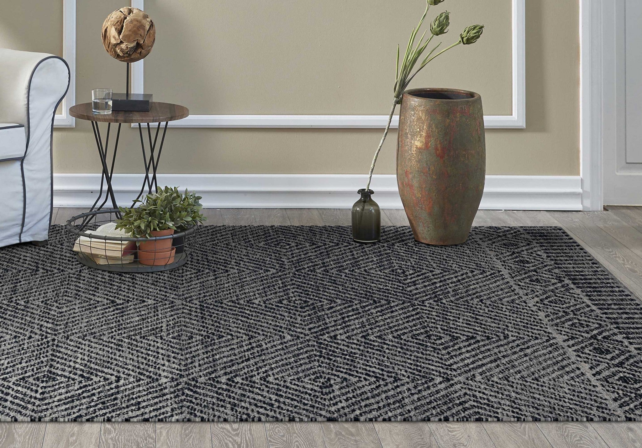 A luxurious 96 x 132 grey and black wool rug, hand-tufted with intricate patterns, perfect for enhancing living room decor.