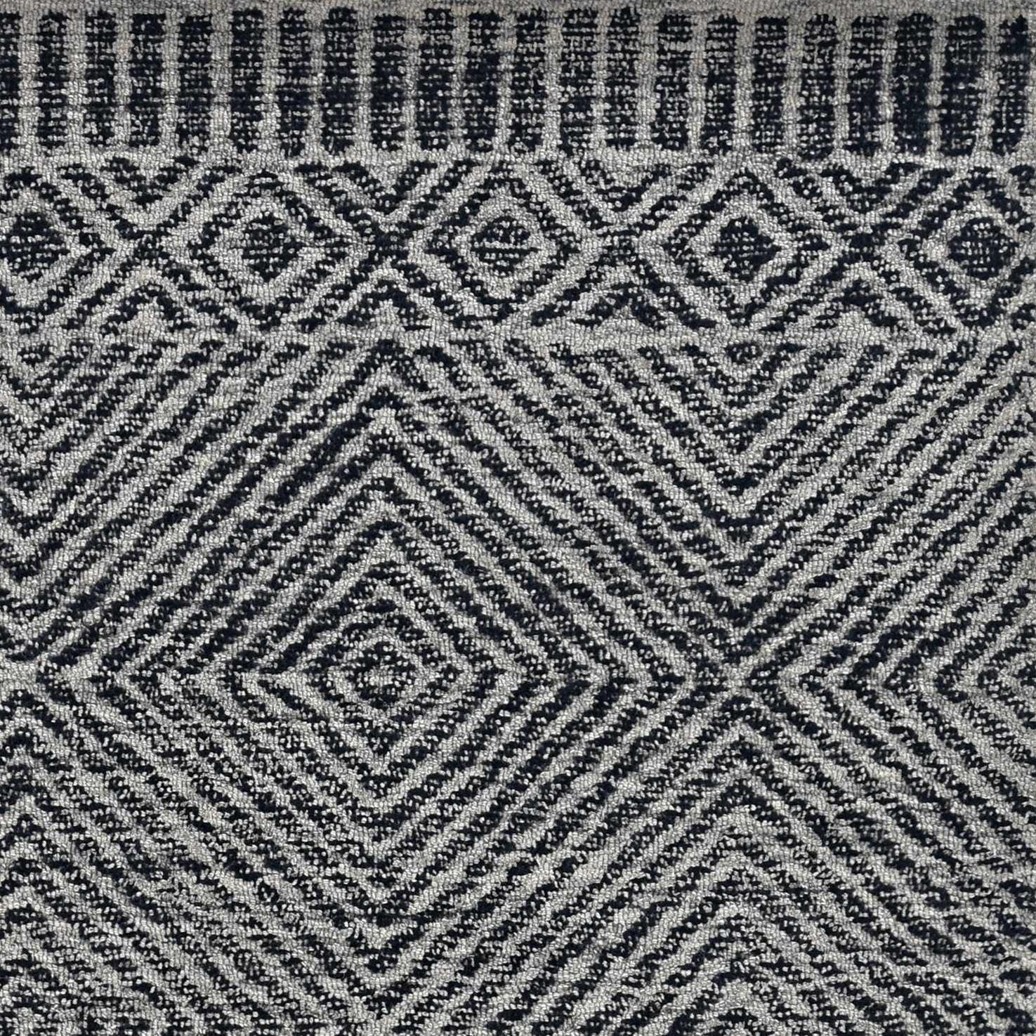 A luxurious 96 x 132 grey and black wool rug, hand-tufted with intricate patterns, perfect for enhancing living room decor.