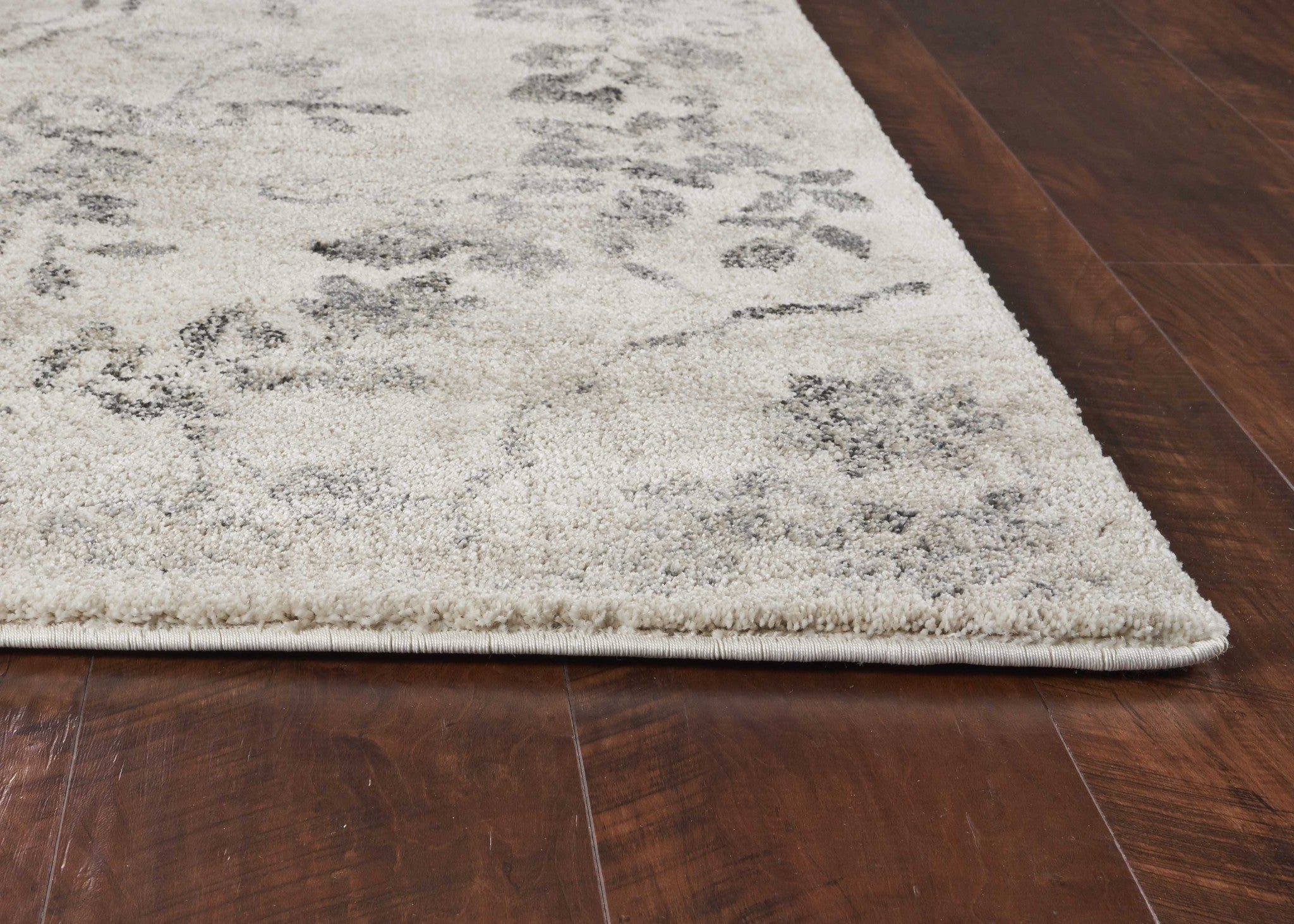 A beautiful 9x13 inches grey machine woven distressed floral traditional rug, showcasing intricate floral patterns and a soft texture, perfect for home decor.