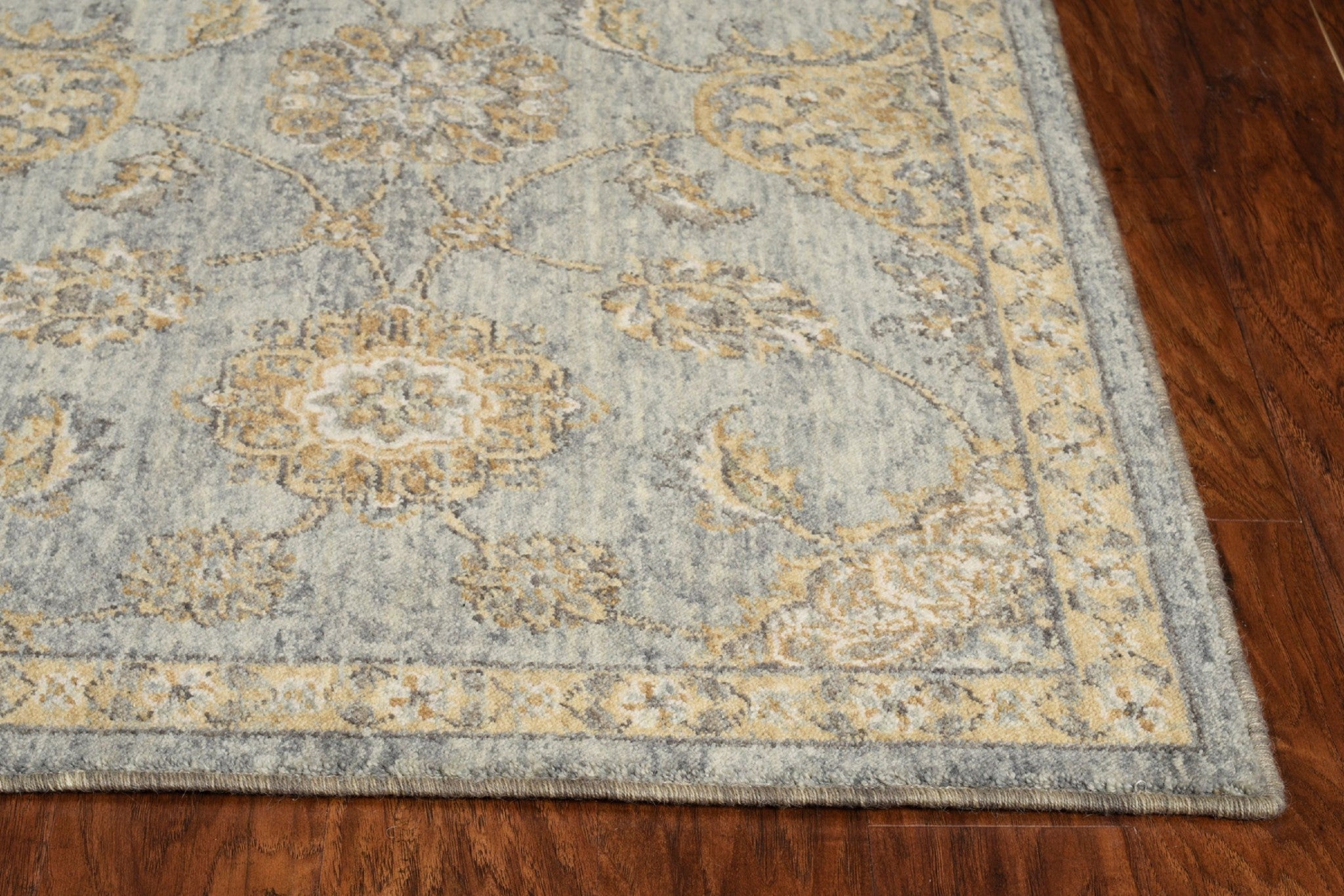 A 9x13 sage green vintage traditional indoor area rug, showcasing intricate patterns and a soft wool texture, perfect for enhancing living spaces.