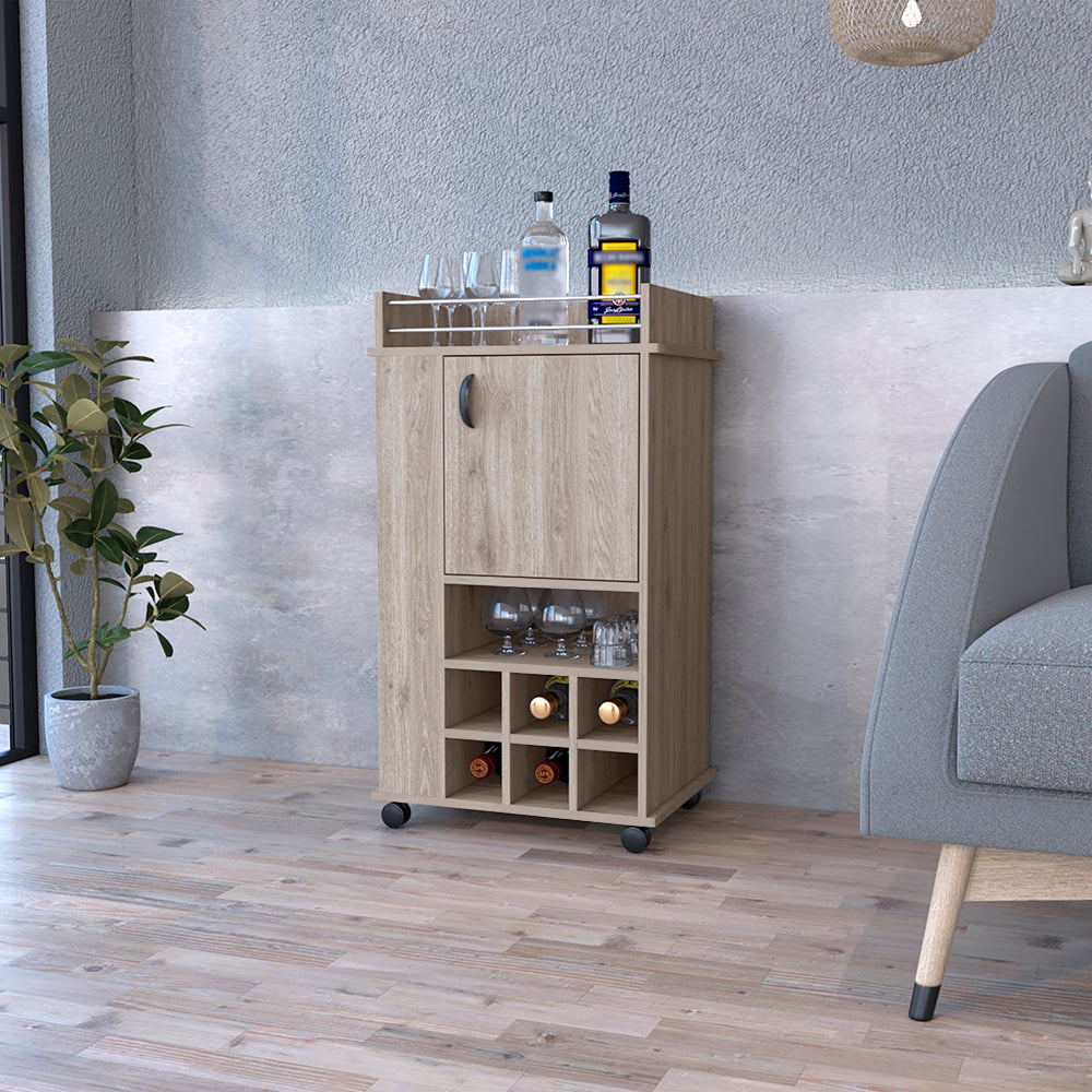 Light gray Reese Bar Cart with casters, featuring six wine cubbies and a single-door cabinet, perfect for home entertaining.