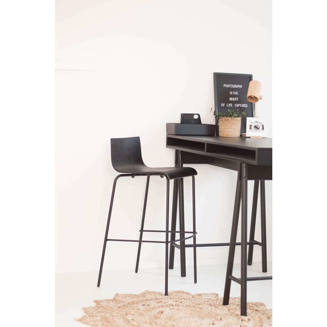 Barstool Pure Oak Black showcasing its elegant oak wood design and comfortable footrest, perfect for kitchen or bar use.