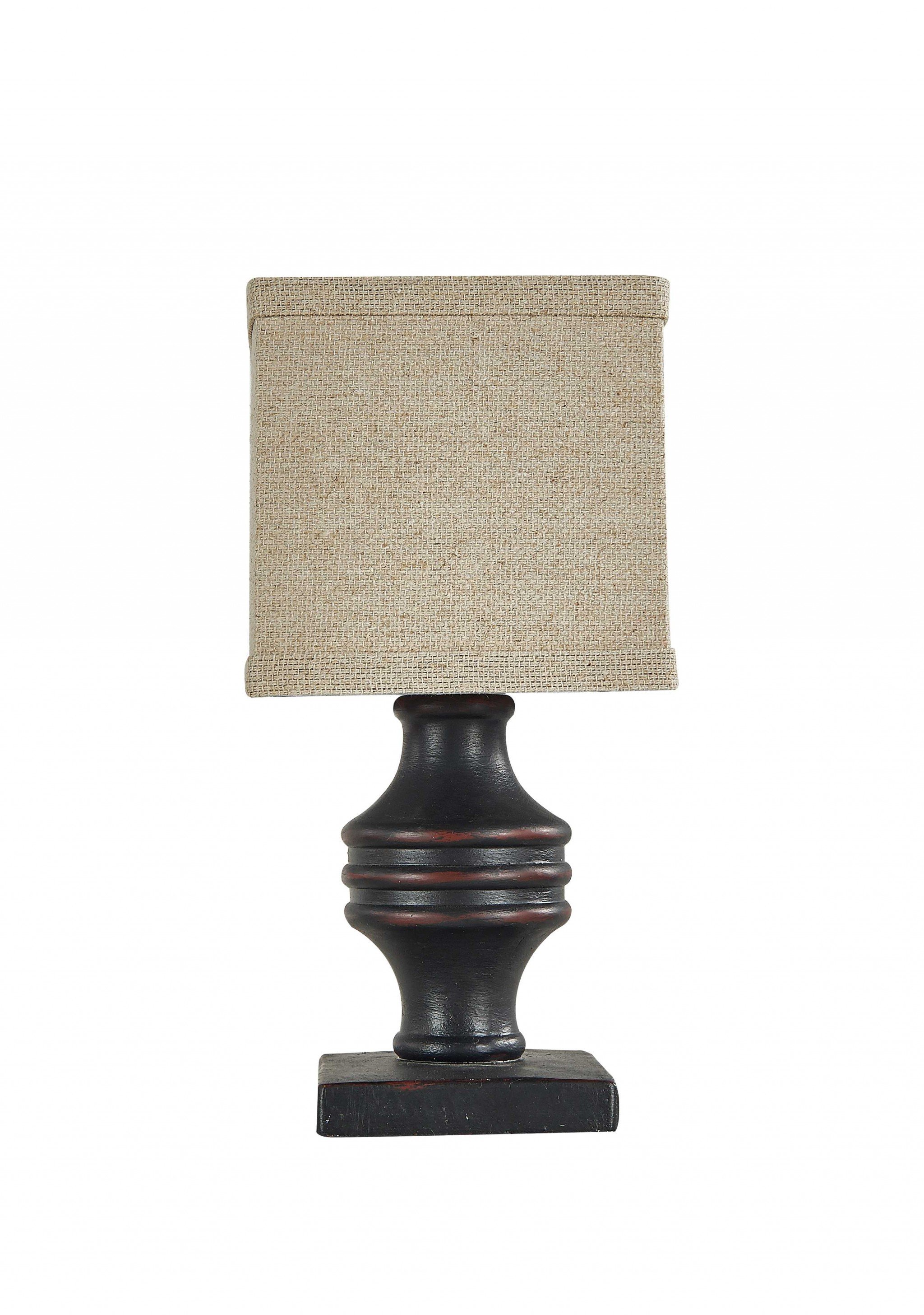 A sleek black accent lamp with a neutral shade, elegantly illuminating a stylish living room setting.