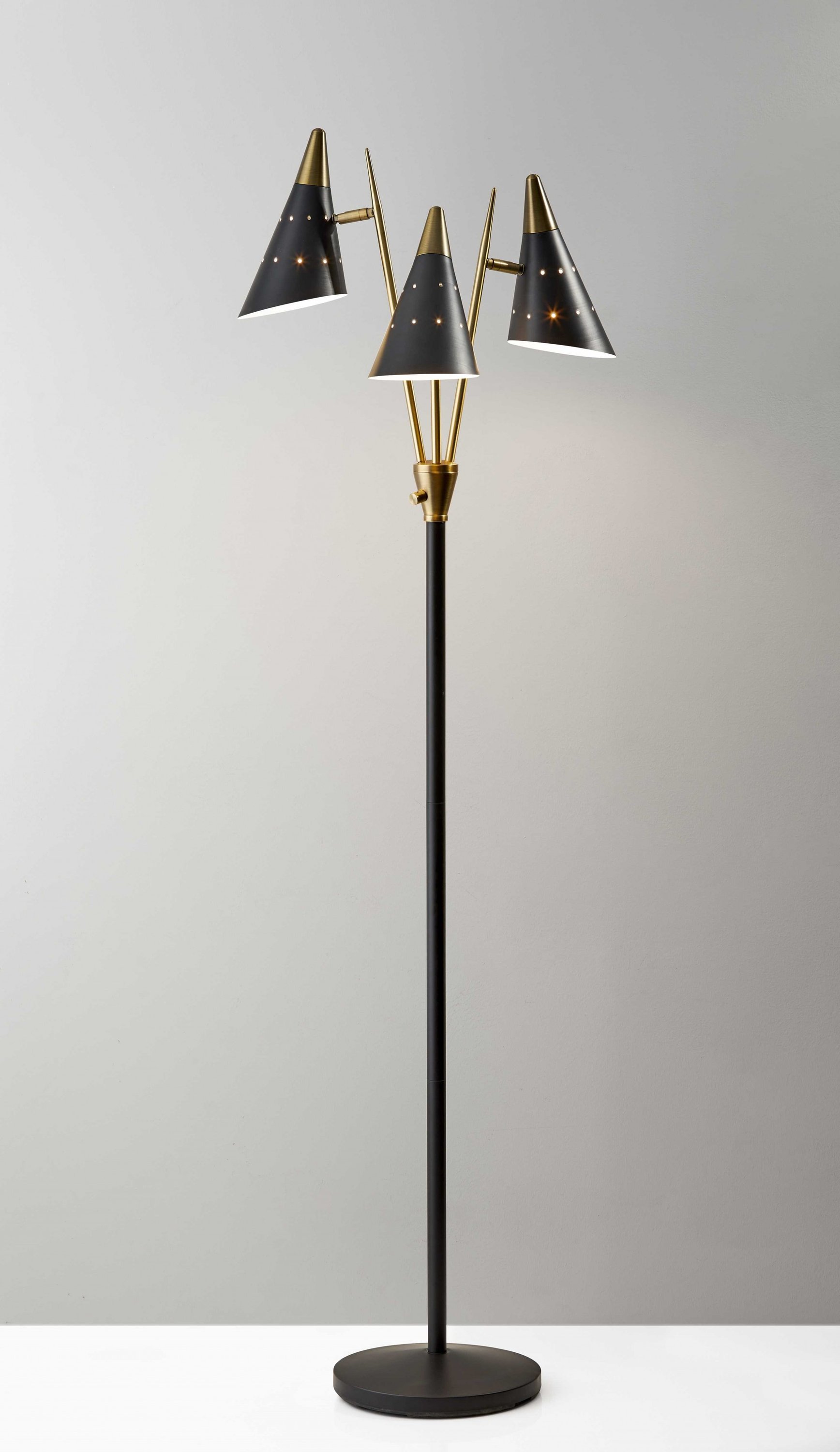 Black metal floor lamp with three adjustable antique brass shades, standing tall with a modern design.