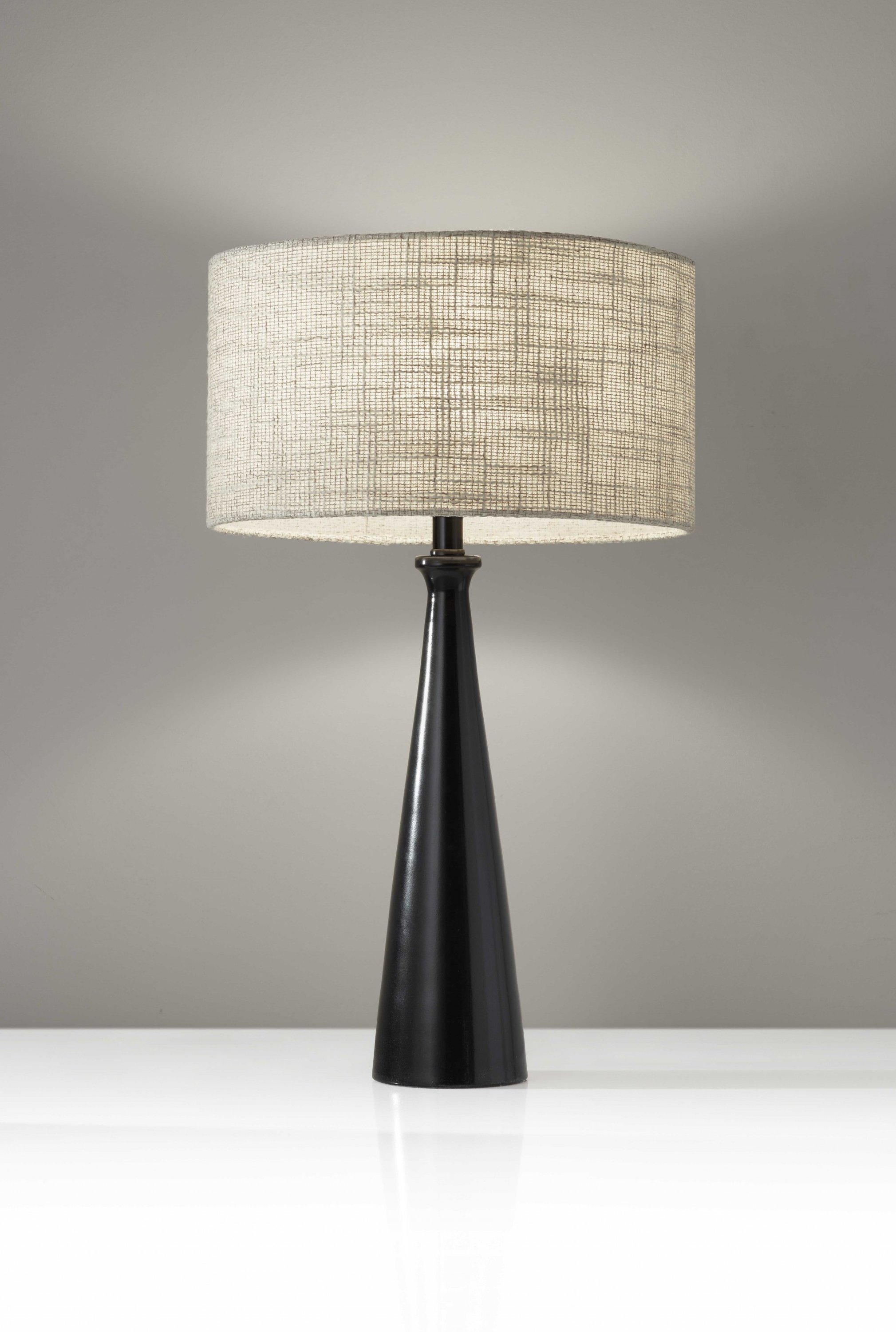 Black Metal Tapered Base Table Lamp with beige fabric shade, showcasing a sleek design and modern aesthetic.