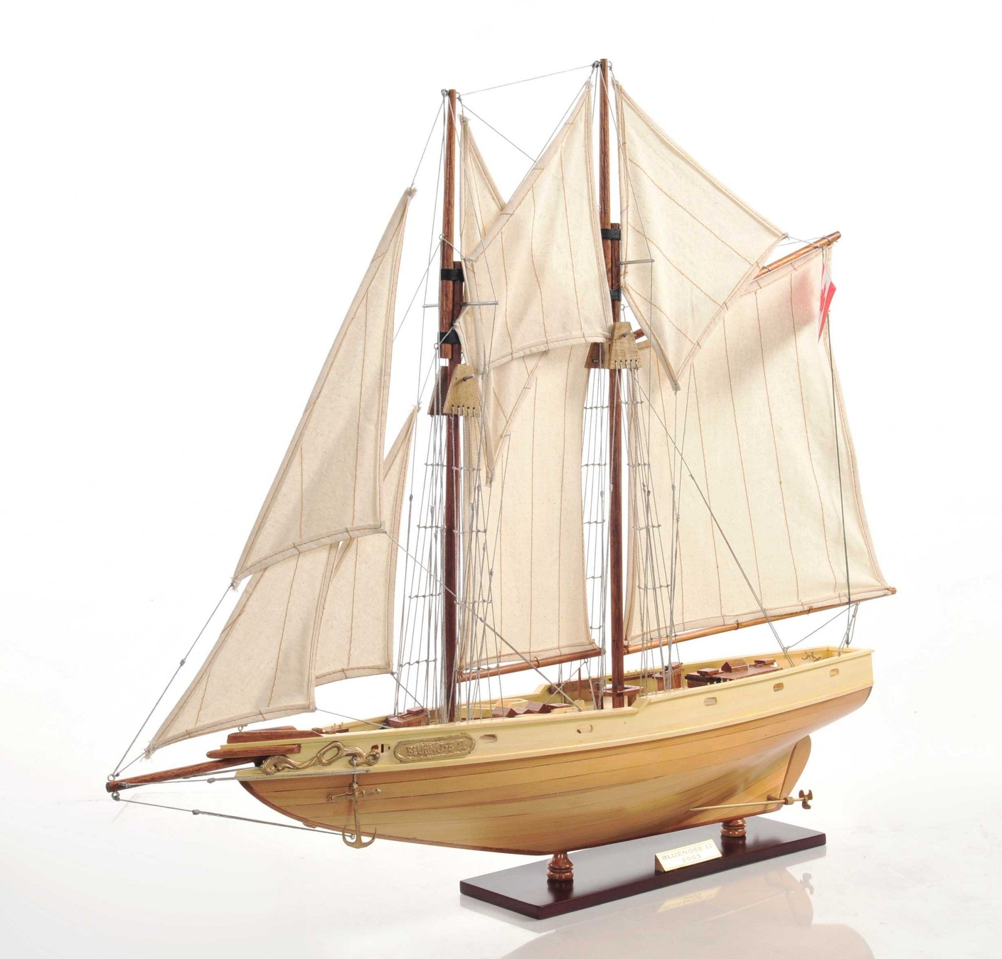 Bluenose model ship in light brown finish showcasing detailed rigging, lifeboats, and wooden craftsmanship.