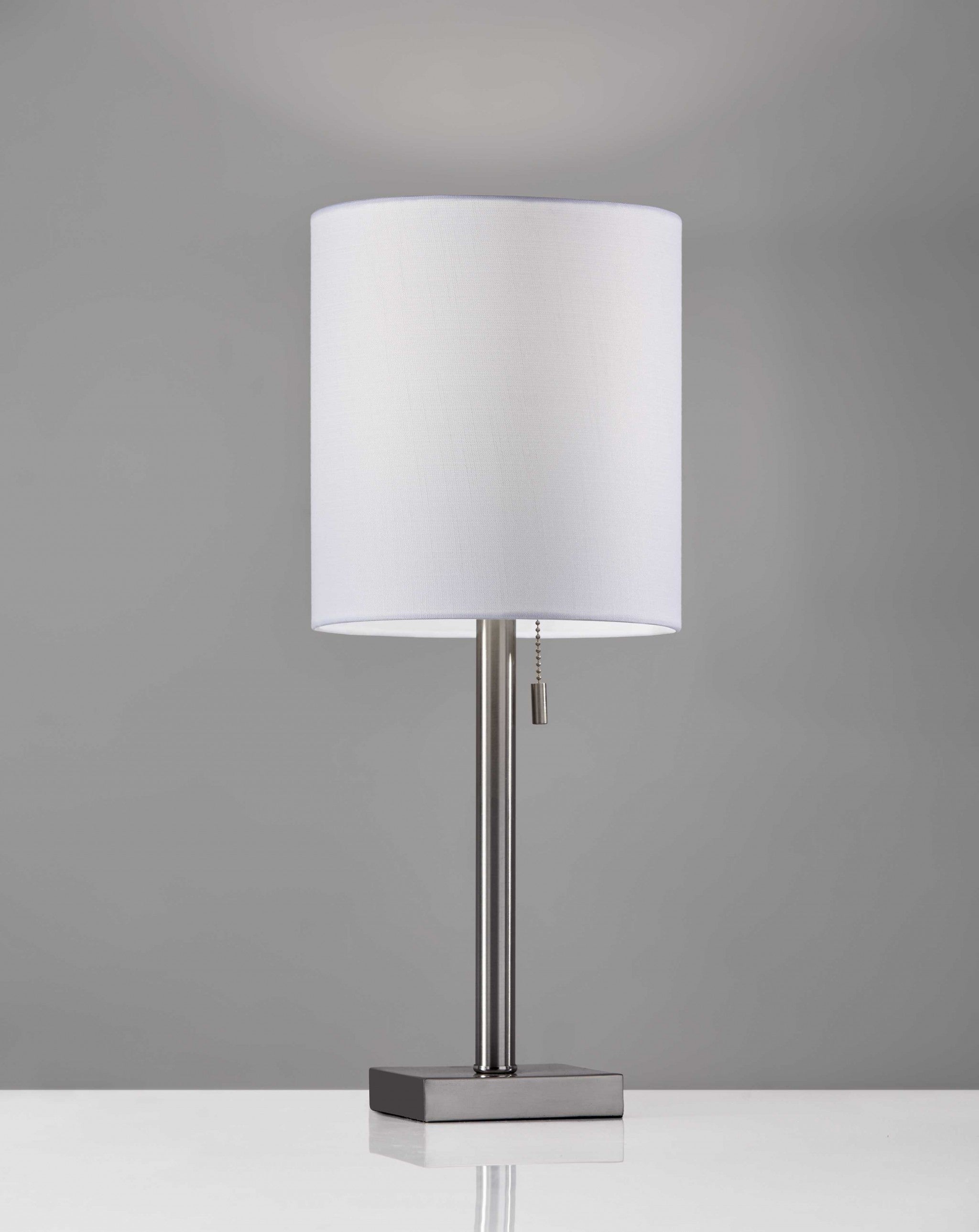 Elegant brass metal table lamp with a light beige fabric shade and a compact square base, perfect for modern decor.