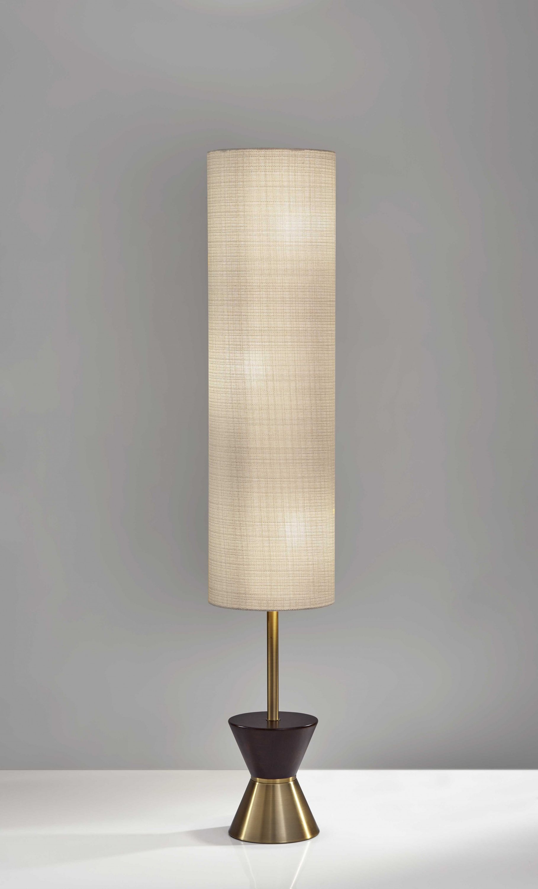 Brass Wood Diabolo Floor Lamp with Tall Textured Beige Shade, showcasing a unique design with a retro influence.