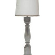 Brown washed wood finish table lamp with a white linen shade, showcasing its elegant design and soft lighting.