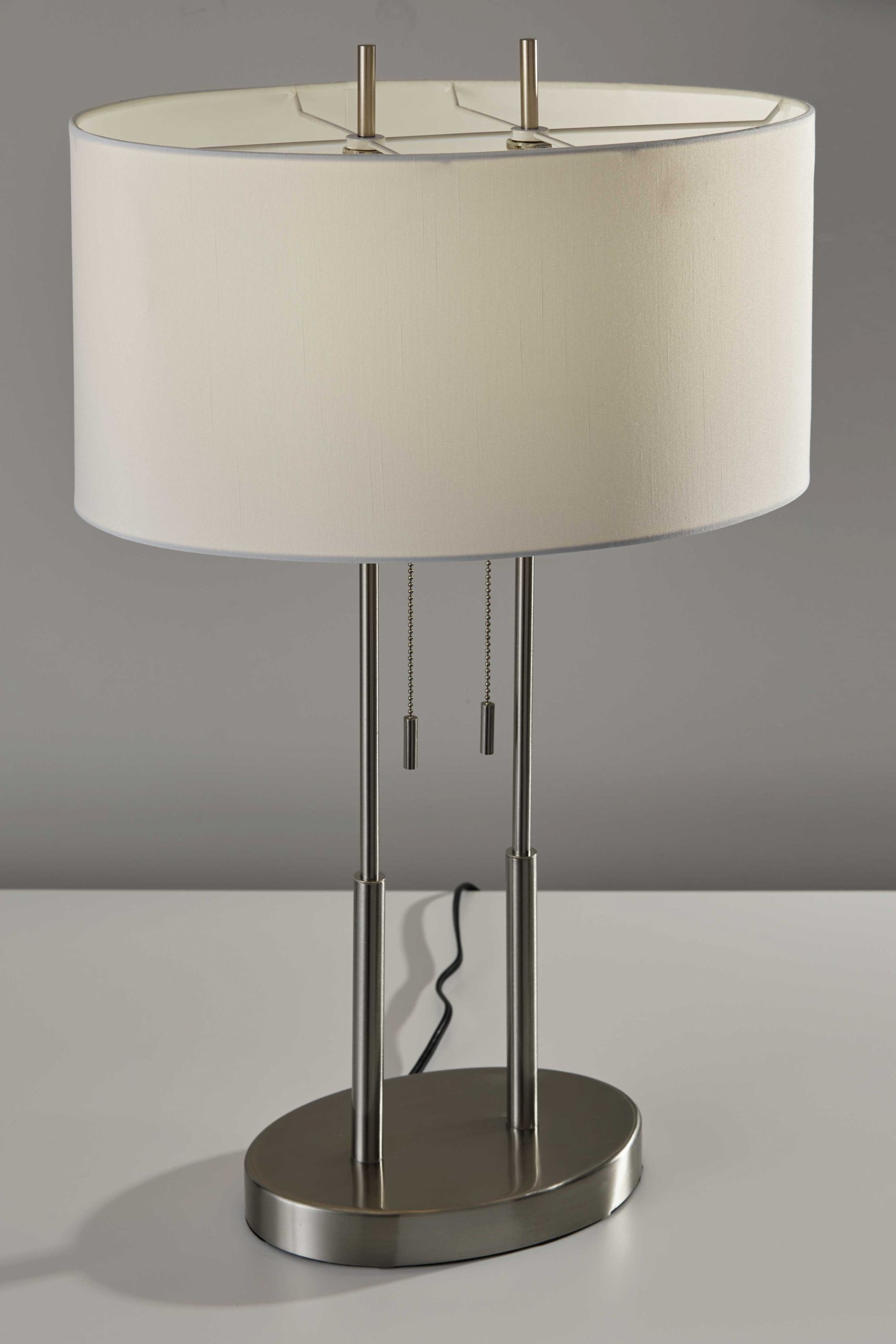 Brushed Steel Dual Pole Metal Table Lamp with off-white oval shade, showcasing modern design and dual pull chain switches.