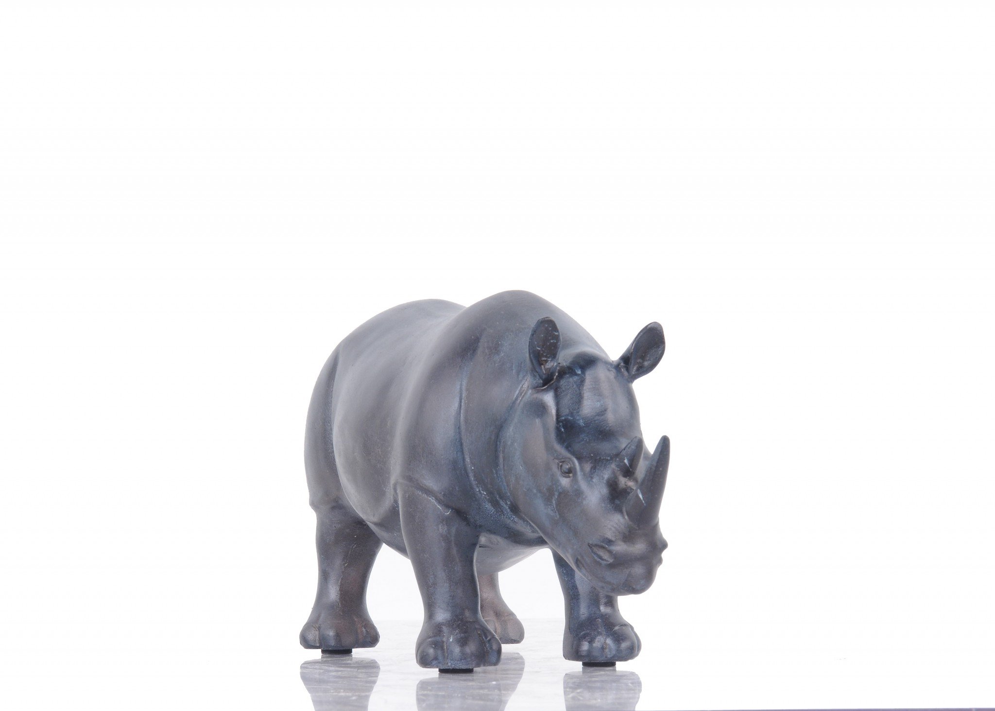 A stunning burnished bronze and black rhinoceros statue, showcasing intricate details and a powerful stance, perfect for home or office decor.