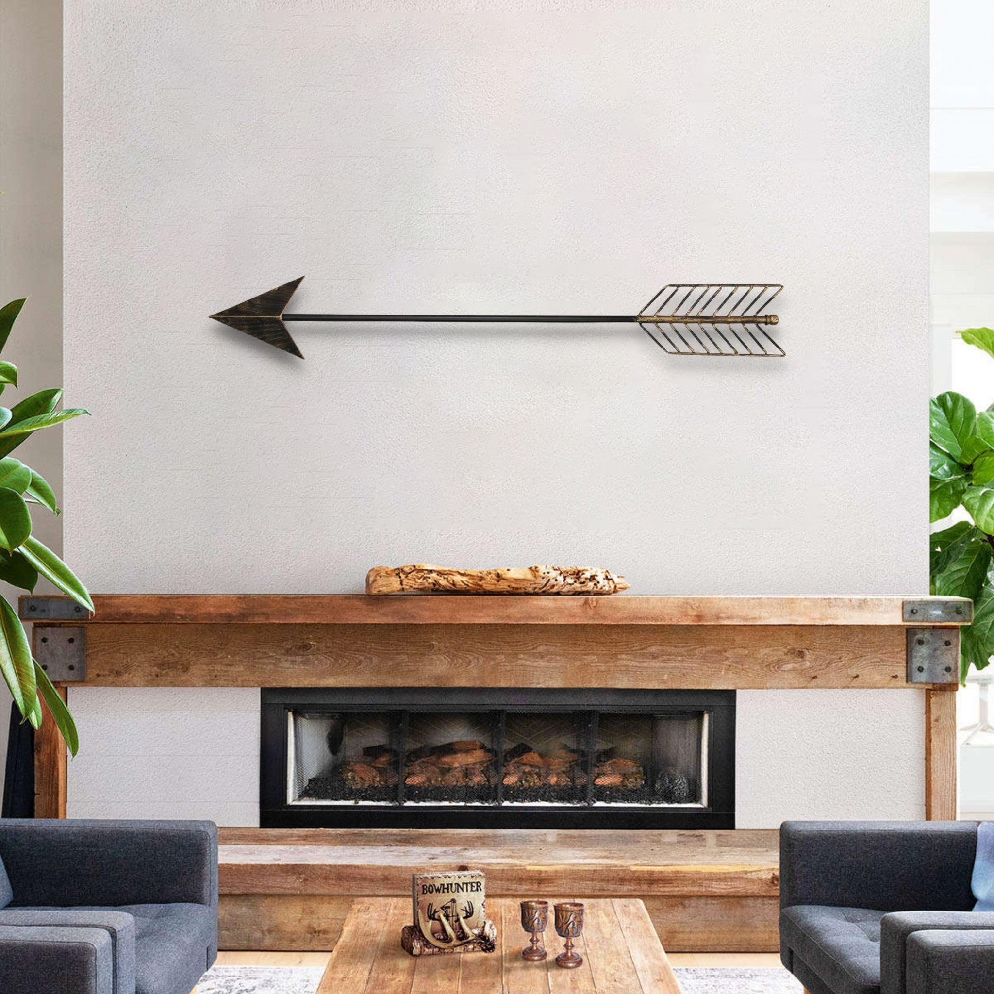 Burnished dark brown and gold tone metal arrow wall decor, showcasing a modern design with a sleek finish, perfect for enhancing interior spaces.