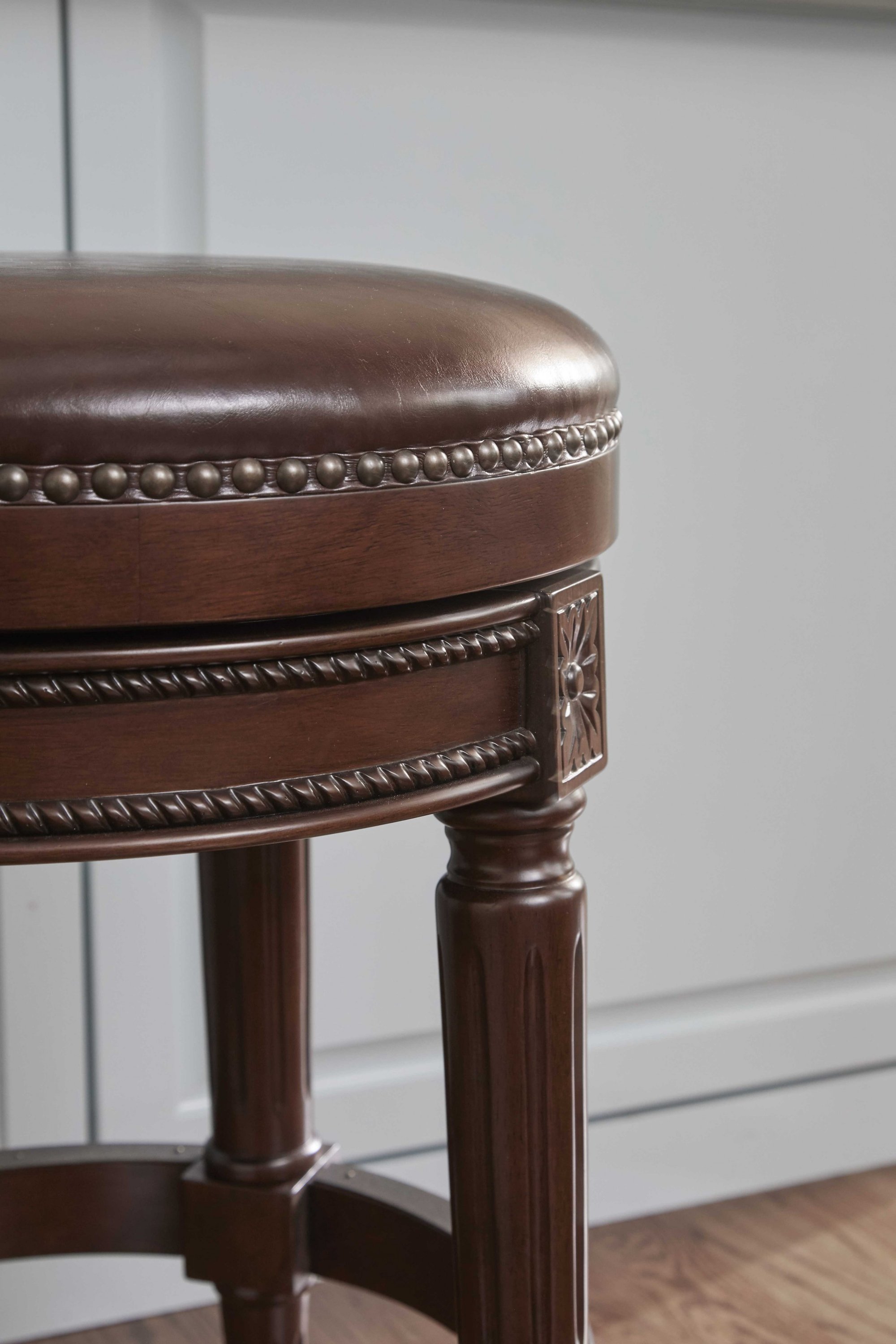 Counter height stool in distressed walnut finish, featuring a backless design and full swivel seat, perfect for modern and rustic interiors.