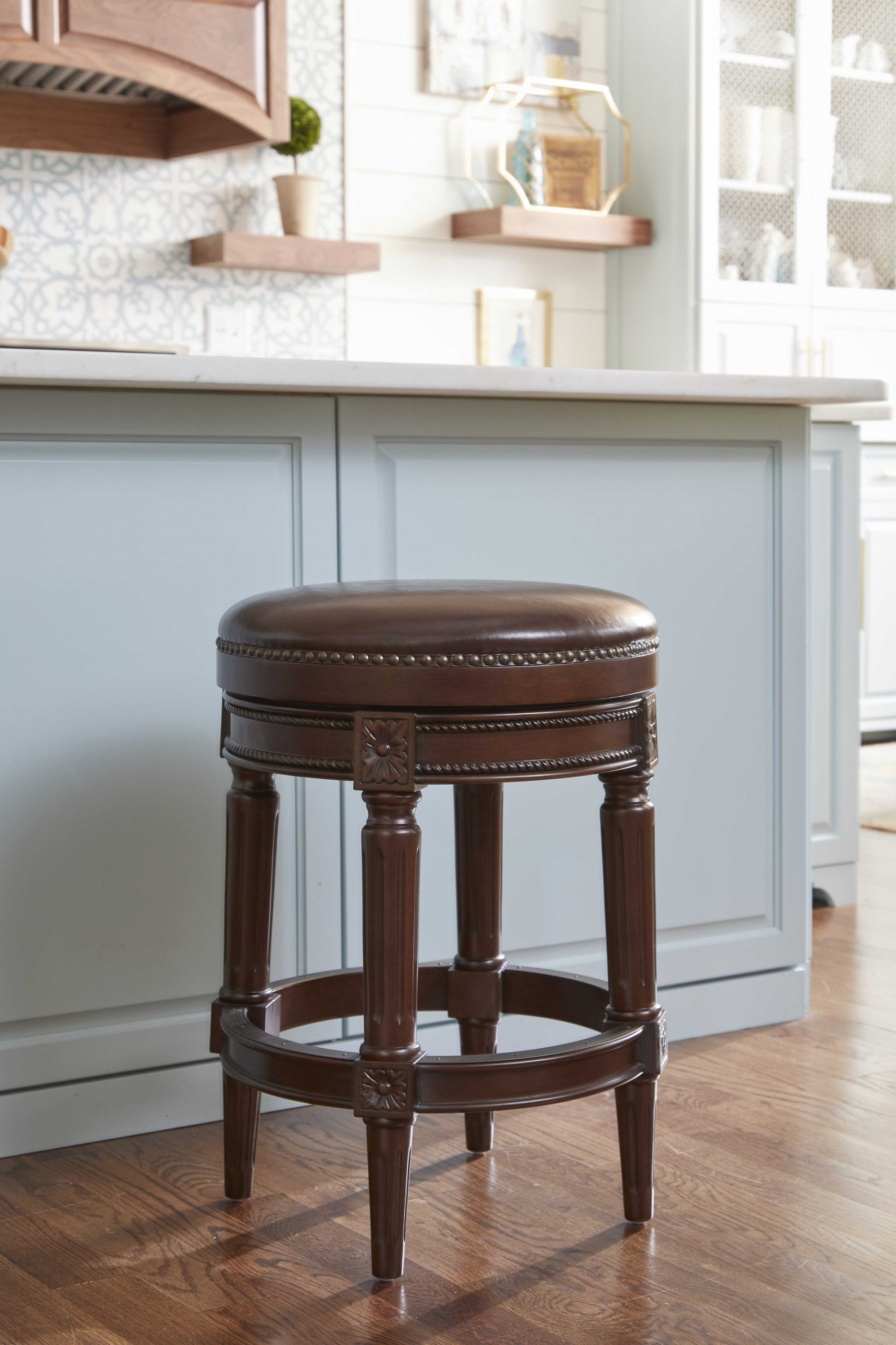 Counter height stool in distressed walnut finish, featuring a backless design and full swivel seat, perfect for modern and rustic interiors.