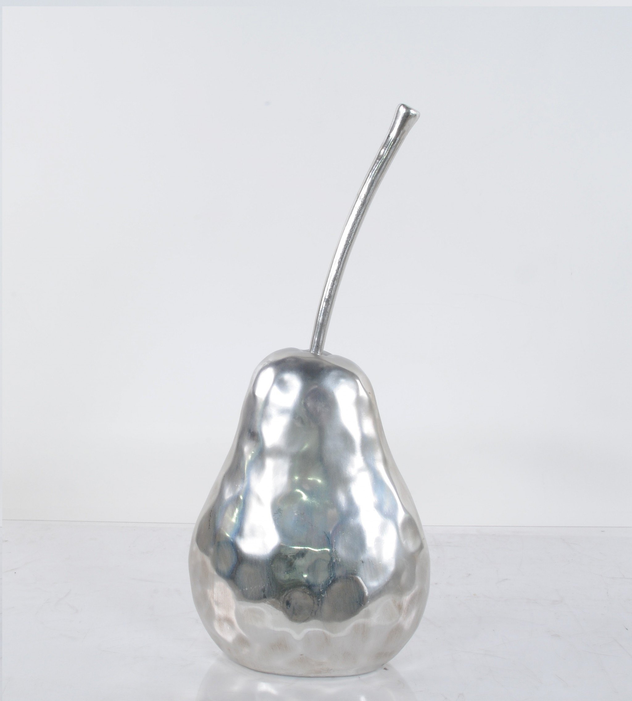 A beautifully crafted pear statue with a hammered nickel finish, showcasing its elegant design and texture, perfect for home decor.