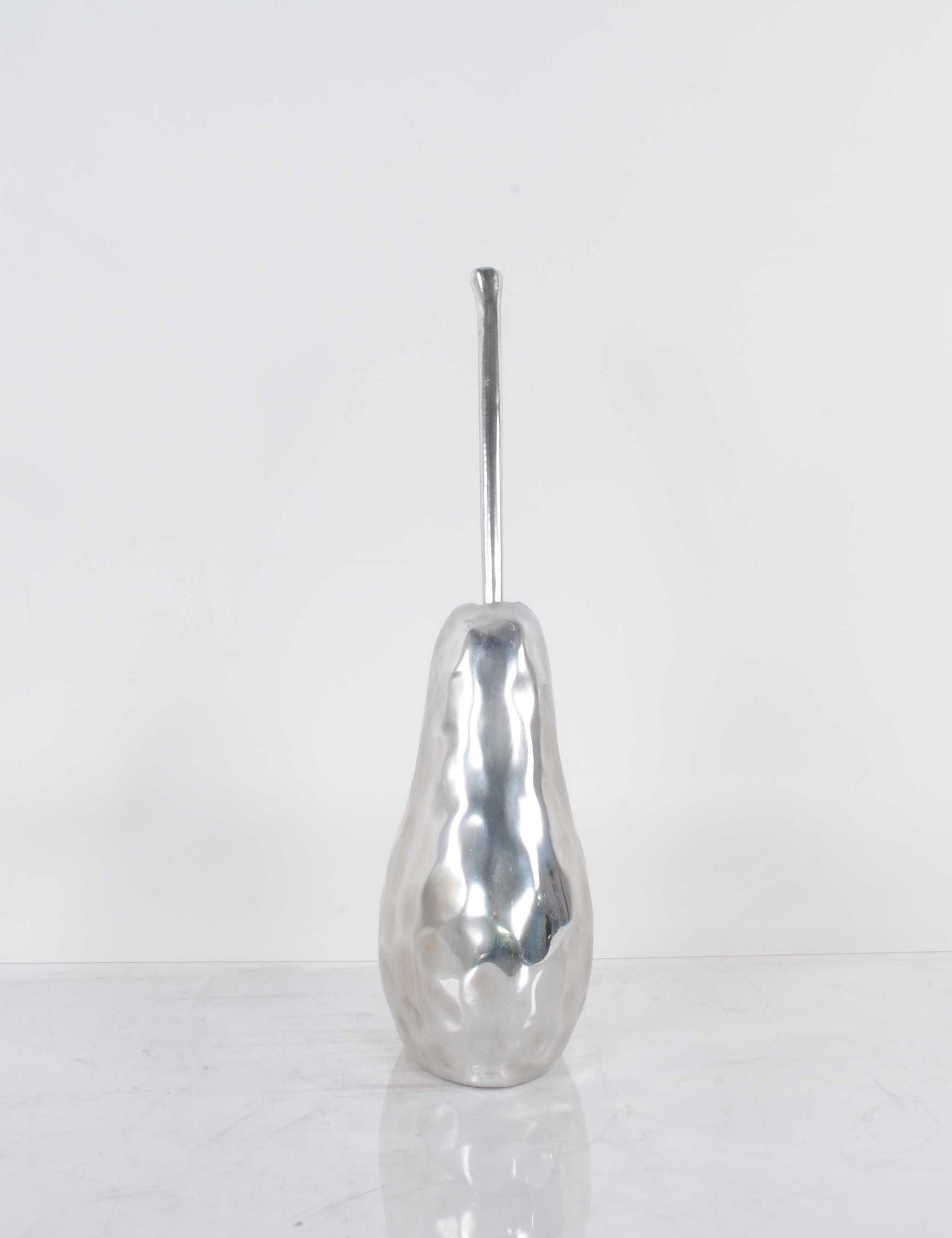 A beautifully crafted pear statue with a hammered nickel finish, showcasing its elegant design and texture, perfect for home decor.