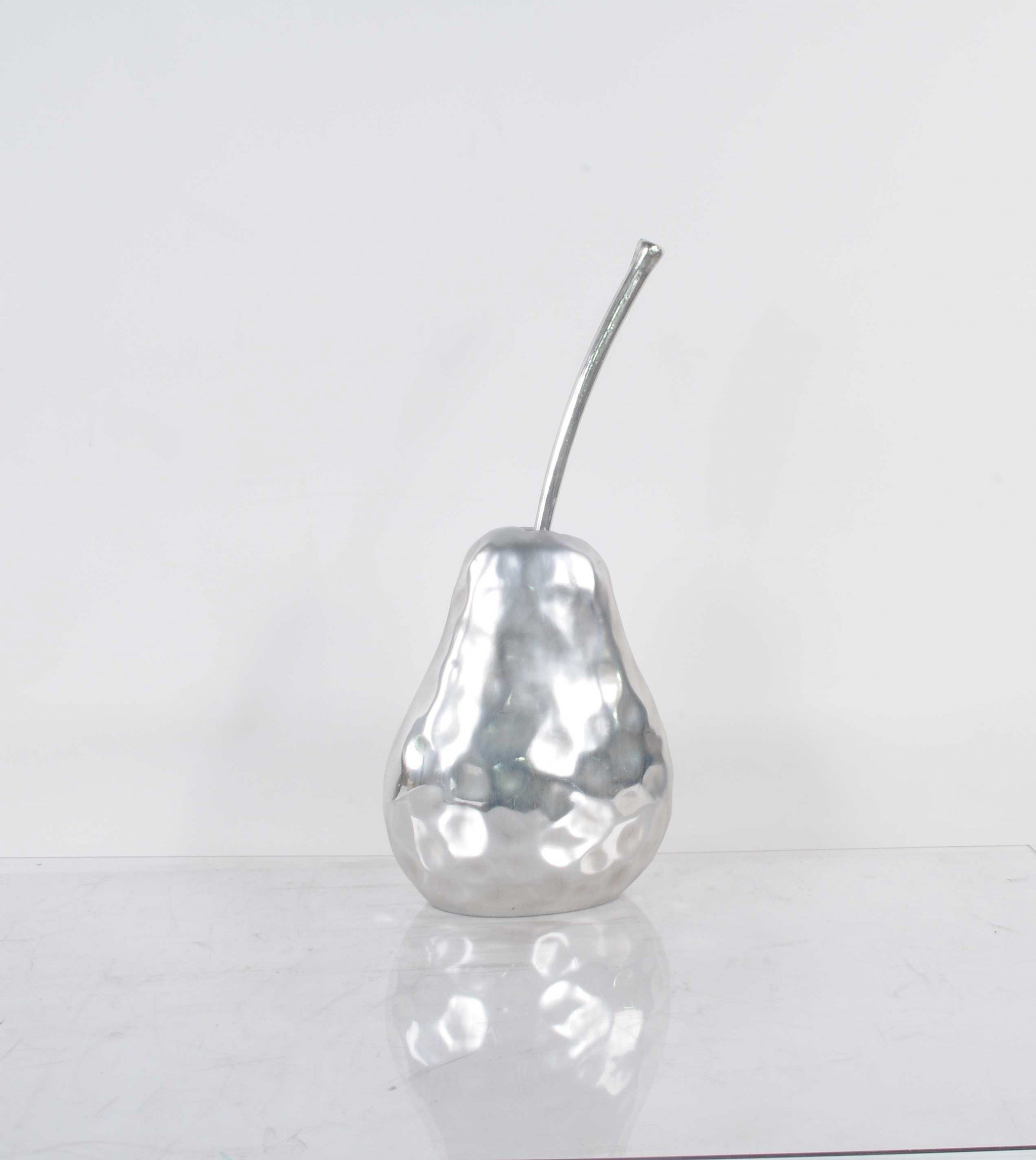 A beautifully crafted pear statue with a hammered nickel finish, showcasing its elegant design and texture, perfect for home decor.