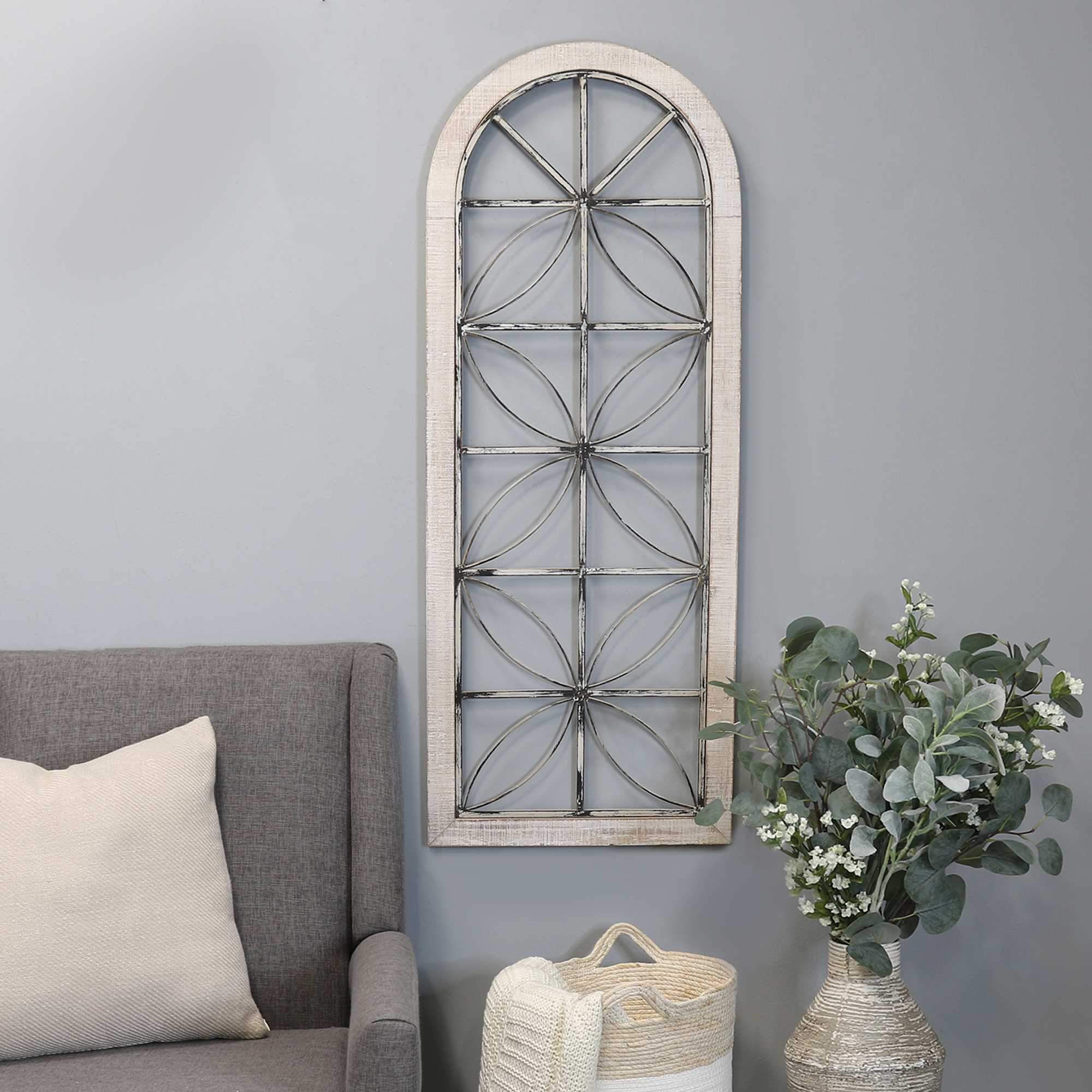 Distressed white metal and wood window panel with geometric patterns, showcasing farmhouse charm.