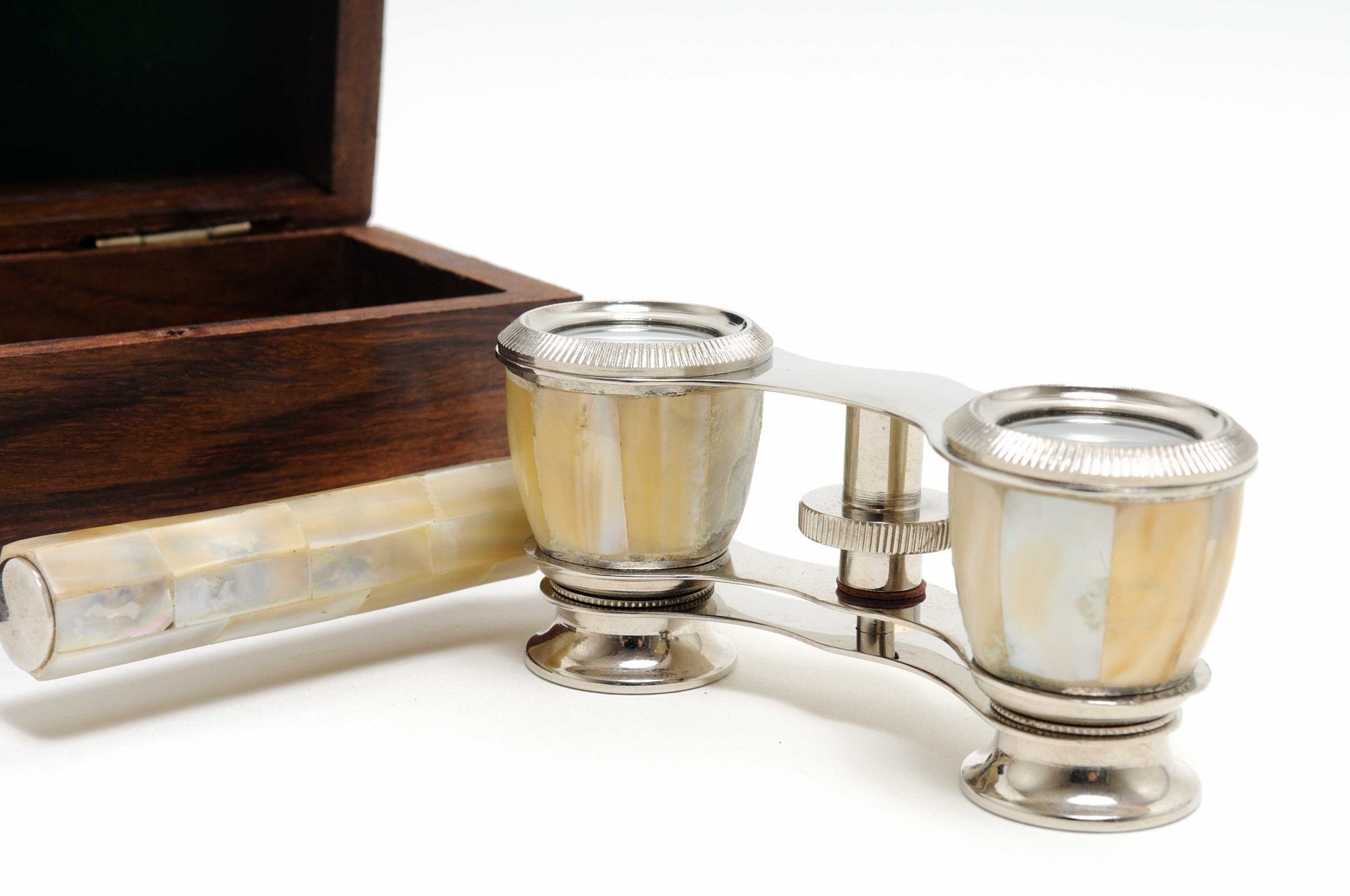 Elegant mother of pearl opera glasses with brass body in a stylish wood storage box, perfect for theater viewing.