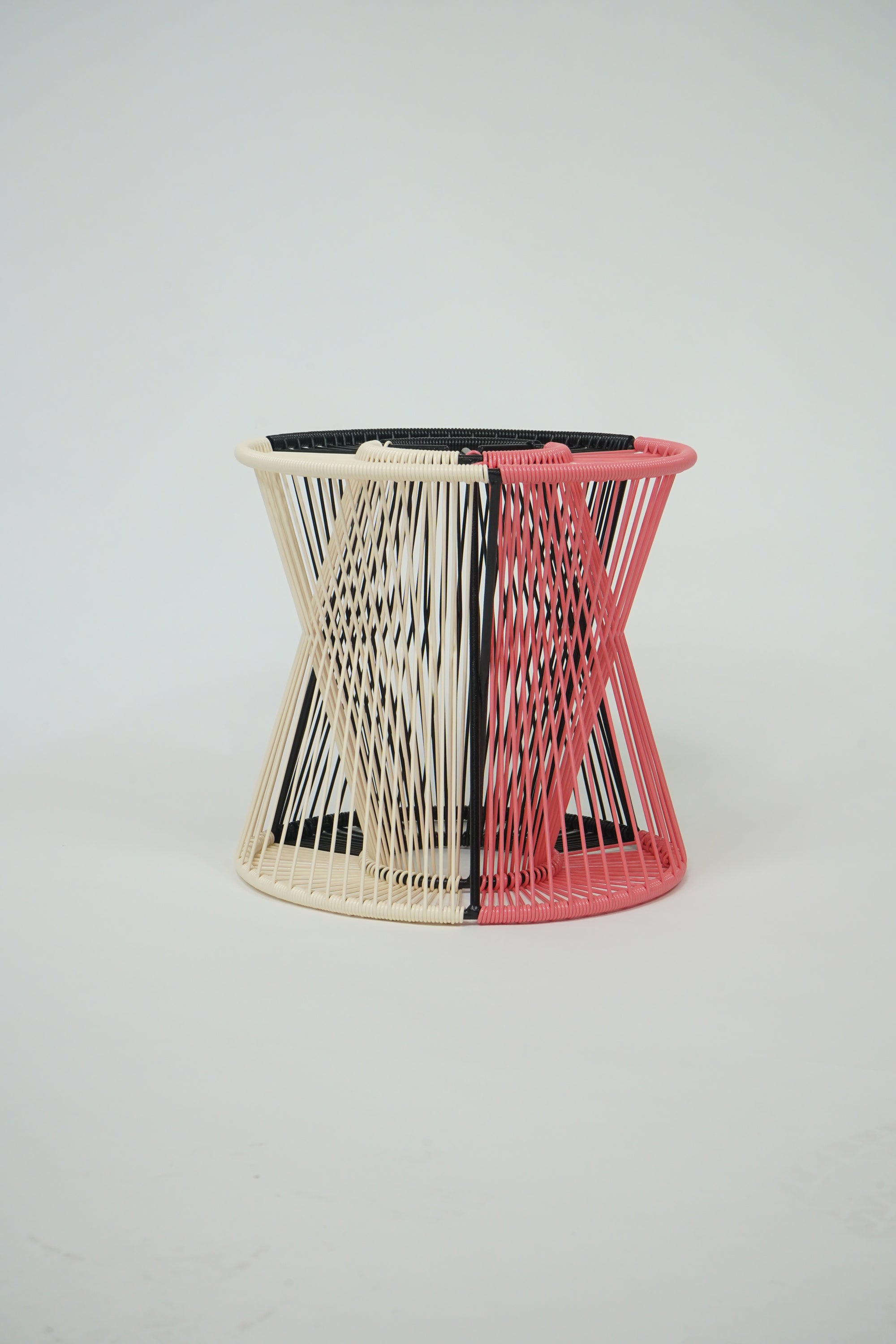 Handcrafted Entre Lamp in black, coral, and ivory colors, showcasing a unique design with a weather-resistant steel frame and vibrant vinyl cord.