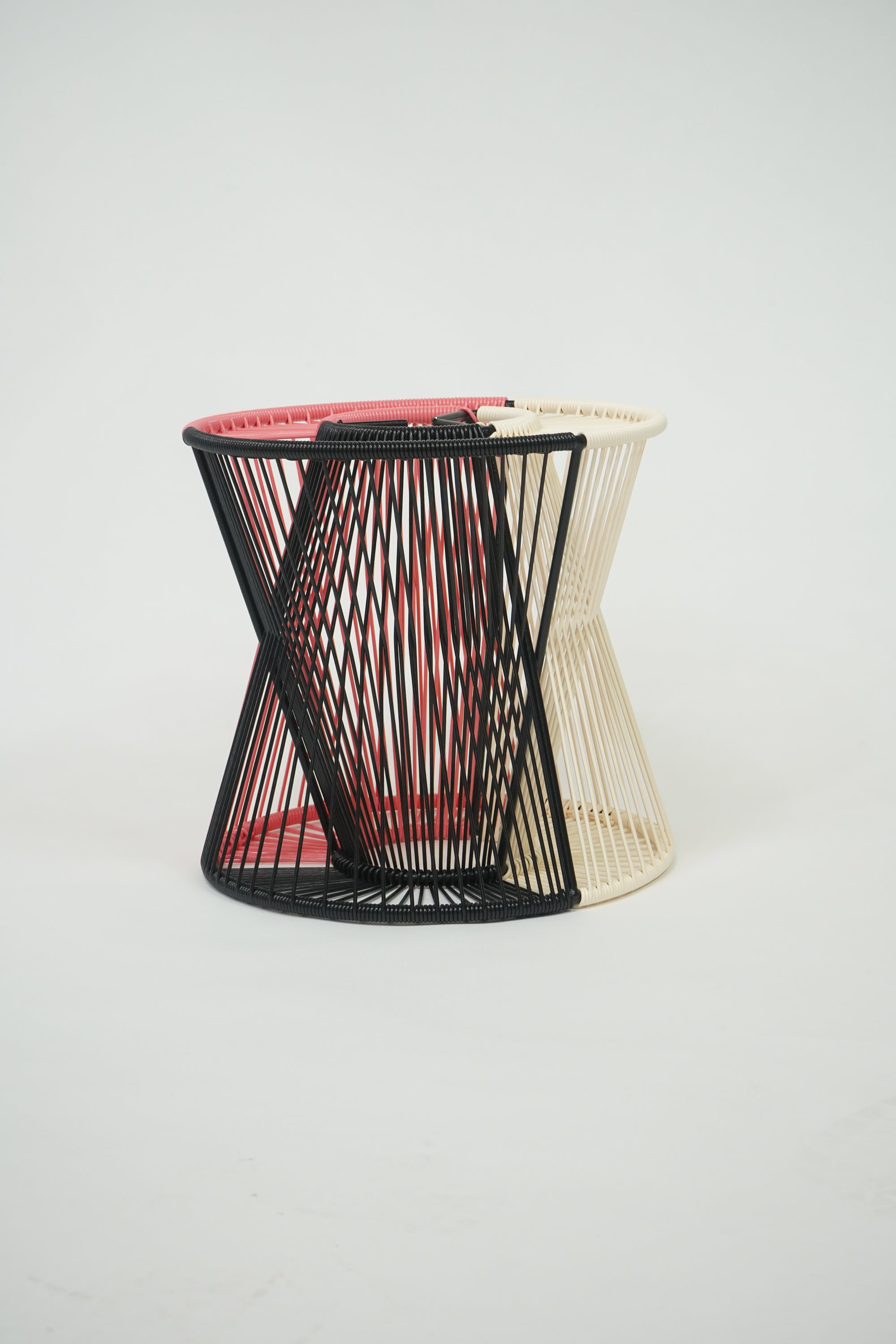 Handcrafted Entre Lamp in black, coral, and ivory colors, showcasing a unique design with a weather-resistant steel frame and vibrant vinyl cord.