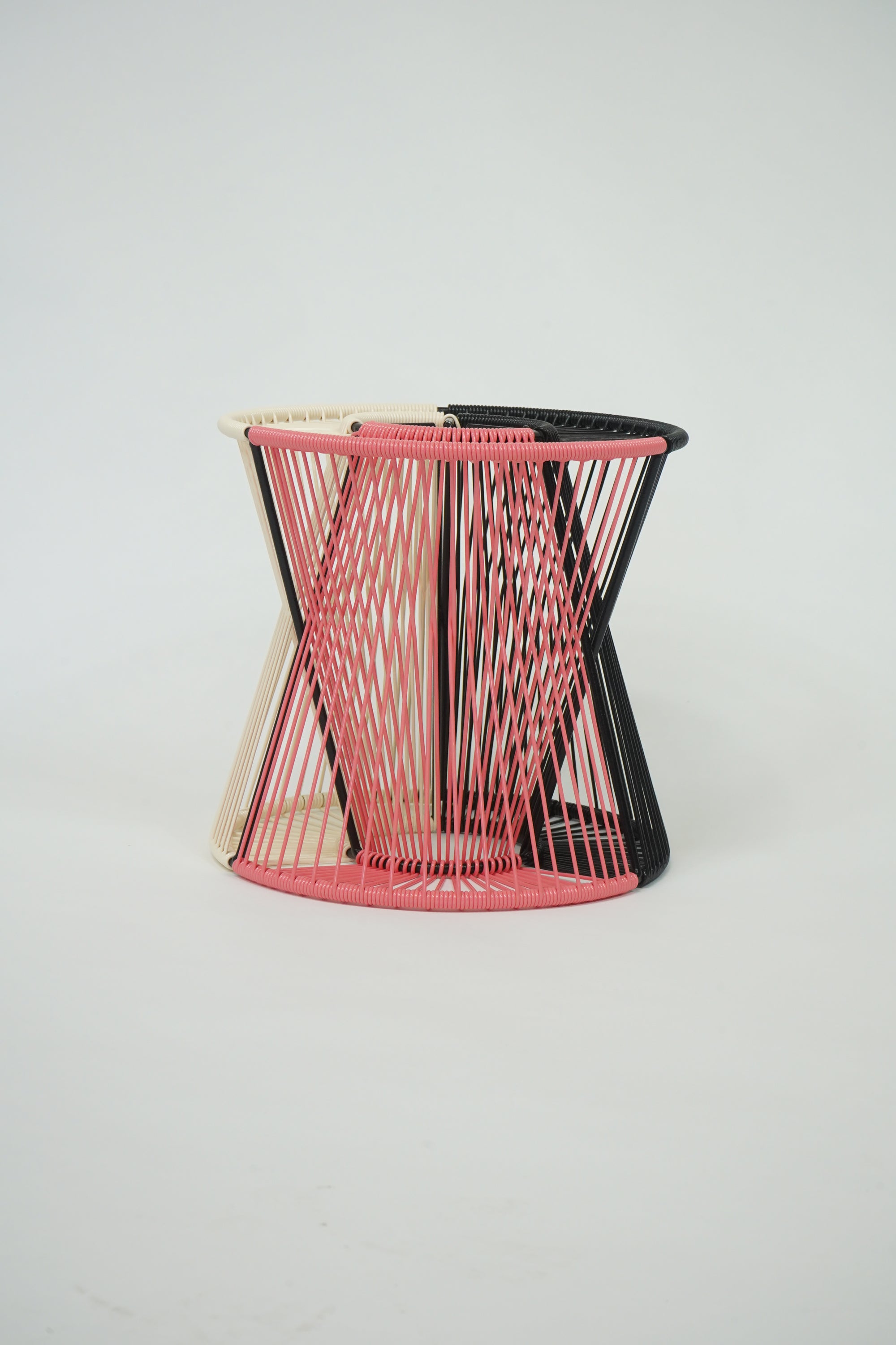 Handcrafted Entre Lamp in black, coral, and ivory colors, showcasing a unique design with a weather-resistant steel frame and vibrant vinyl cord.