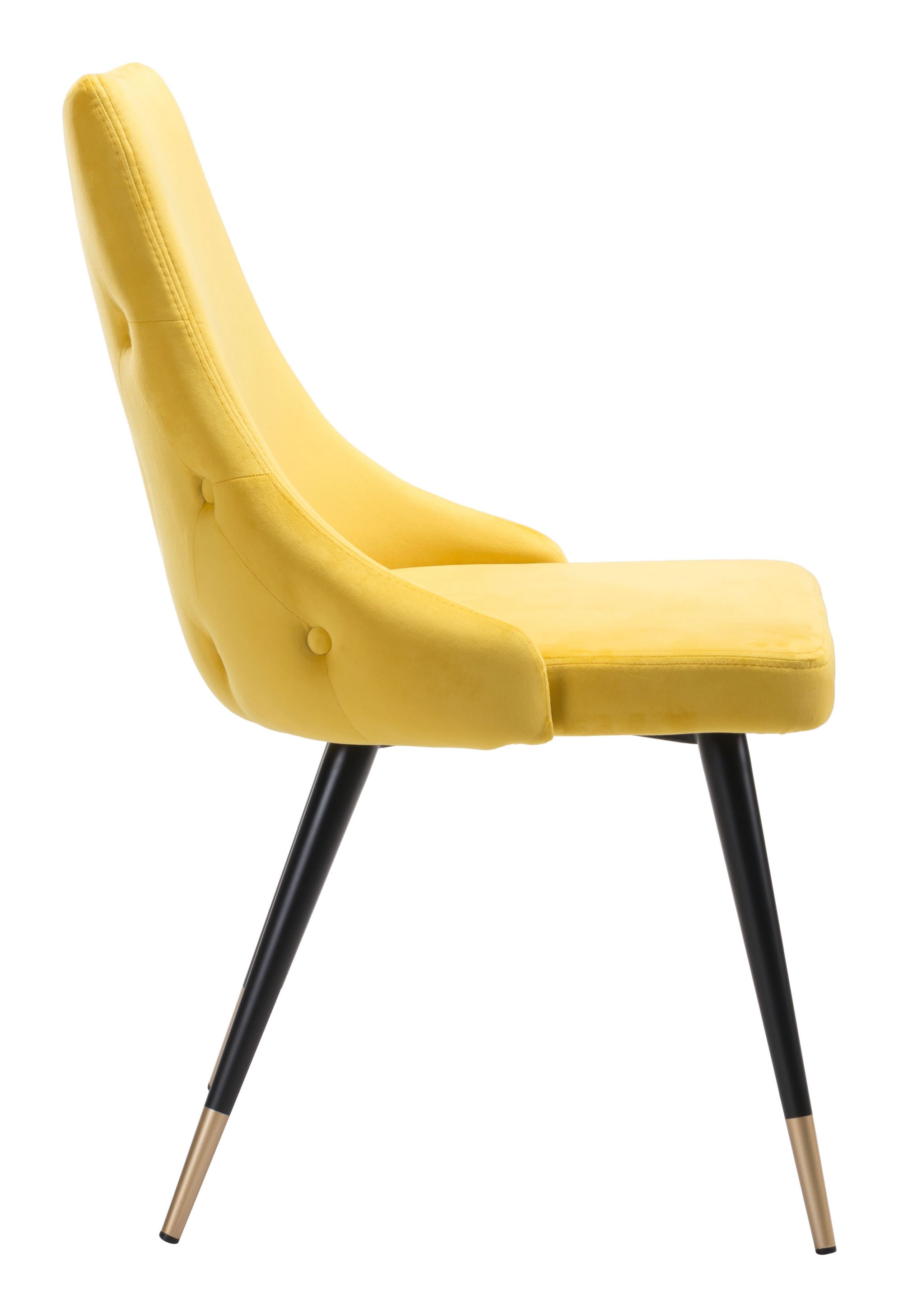 A set of two fashionable canary yellow velvet dining or side chairs featuring button tufting and black legs with brass tips.