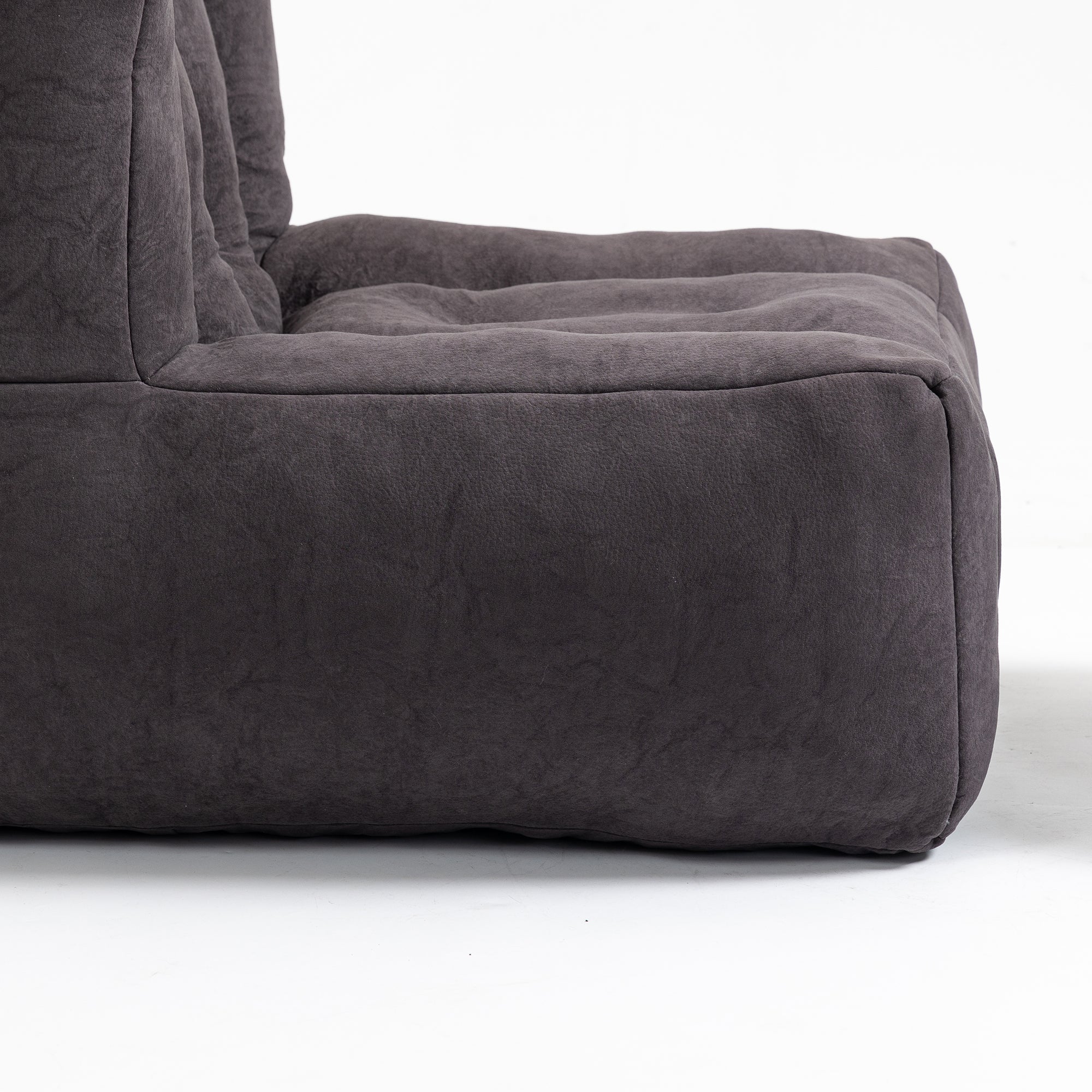 Fluffy bean bag chair in black velvet, designed for comfort and support, suitable for adults and children.