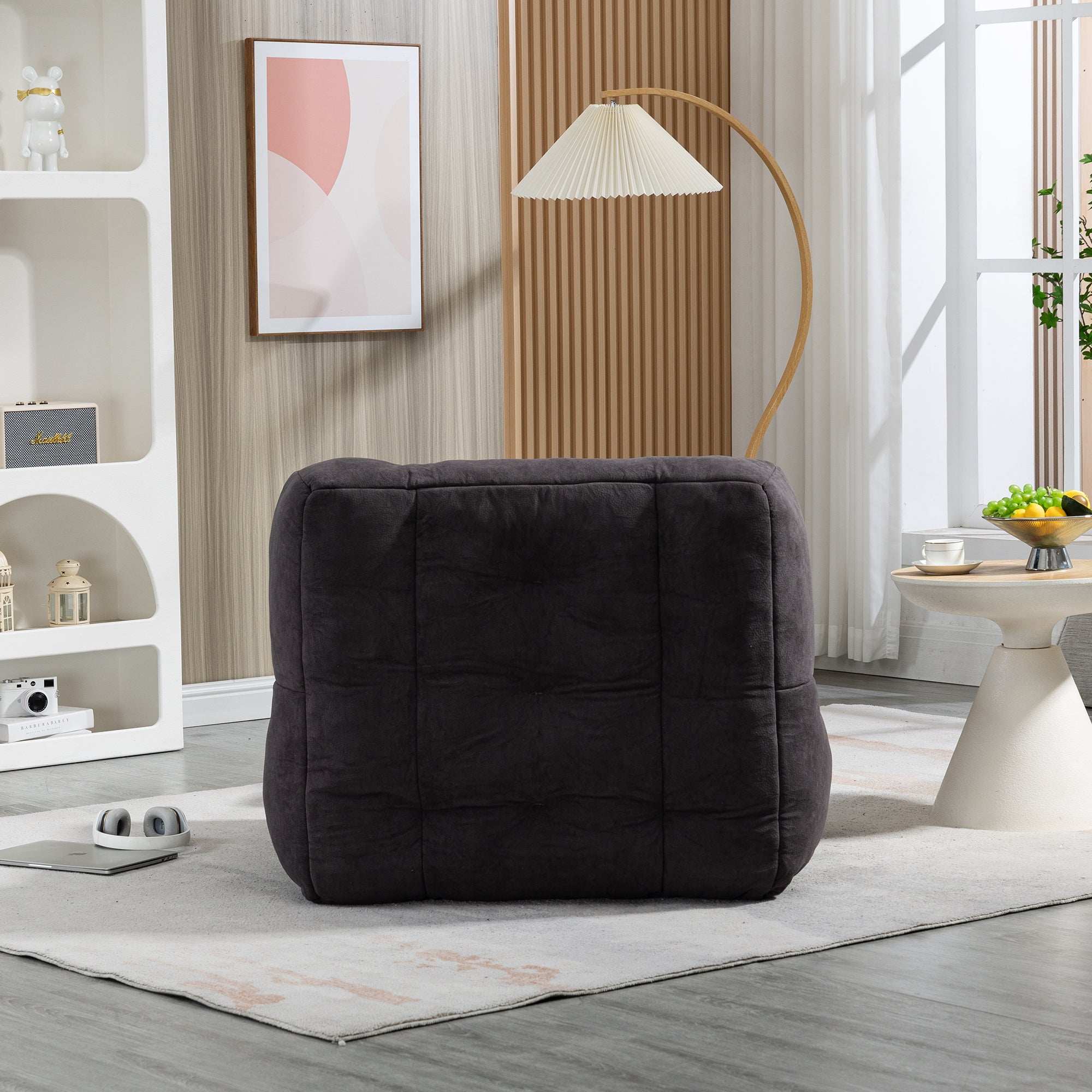 Fluffy bean bag chair in black velvet, designed for comfort and support, suitable for adults and children.