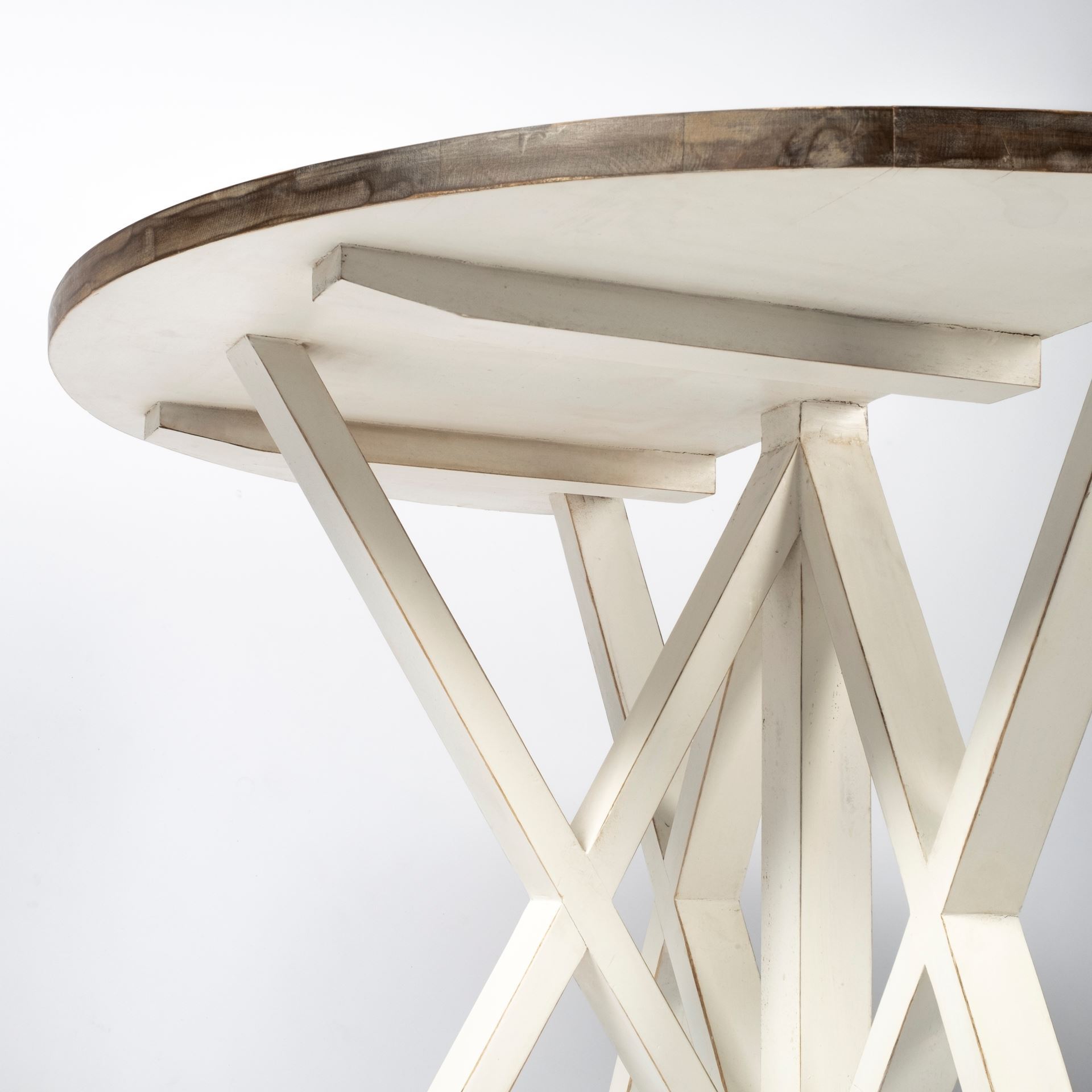 Half moon shaped console table made of mango wood with a white finish, featuring a geometric base for stability.