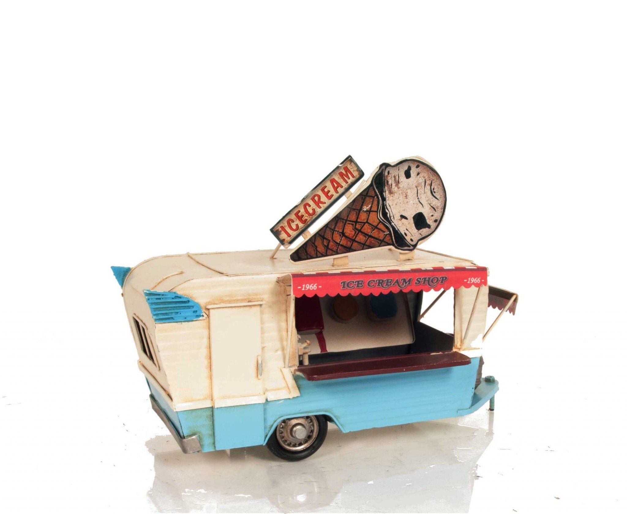 A detailed handmade metal model of an ice cream trailer featuring vibrant signs, a freezer, and turnable wheels.