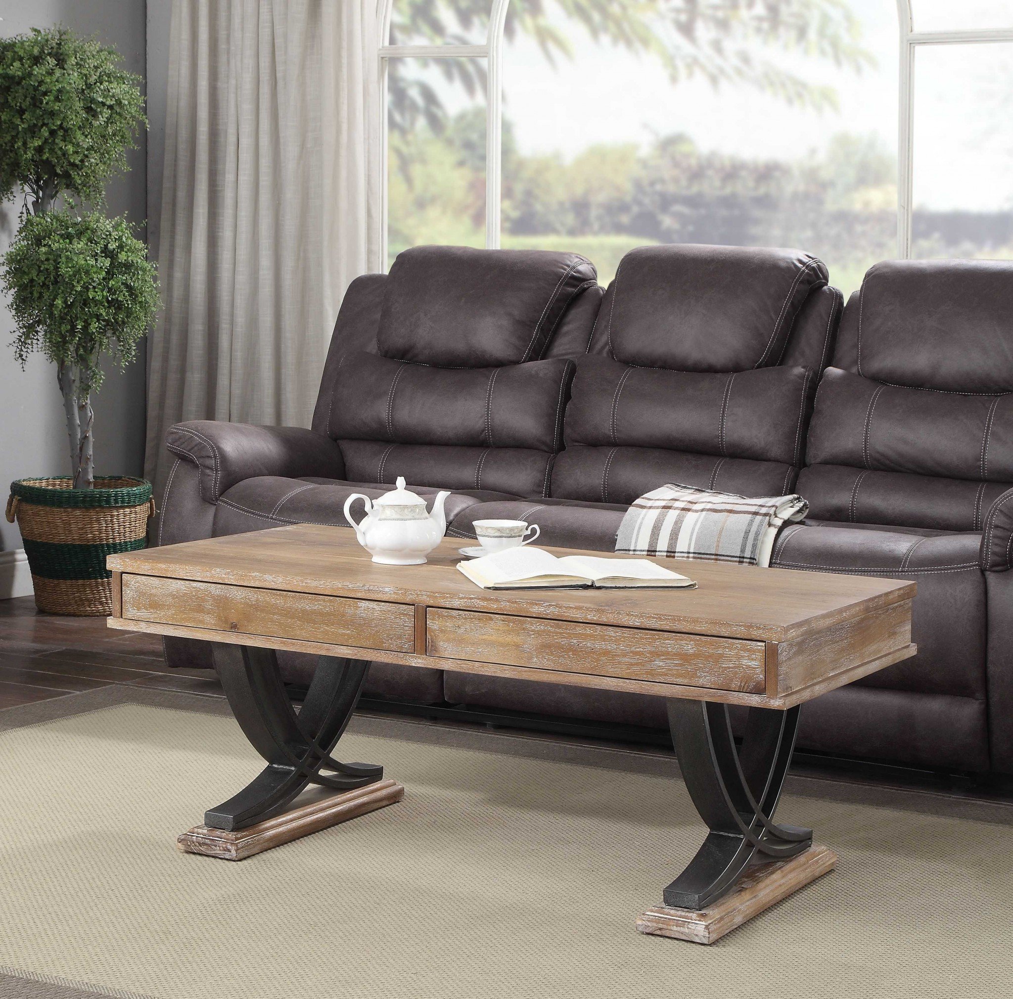 Industrial style coffee table with antiqued oak finish and black metal accents, featuring a wide tabletop and two pull-out drawers for storage.