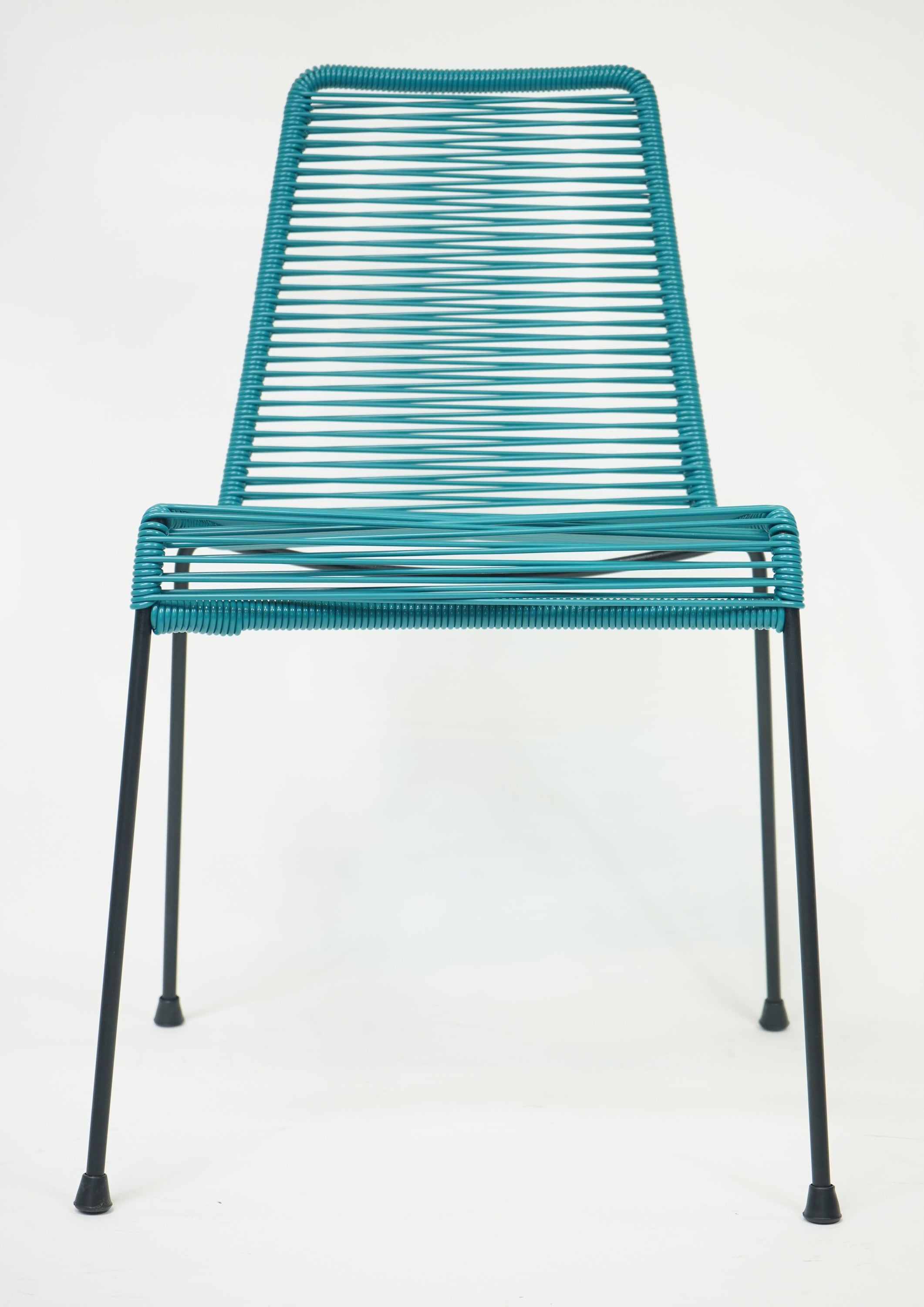 La Turquesa Chair in vibrant turquoise and black, showcasing its contemporary design and inviting curves.