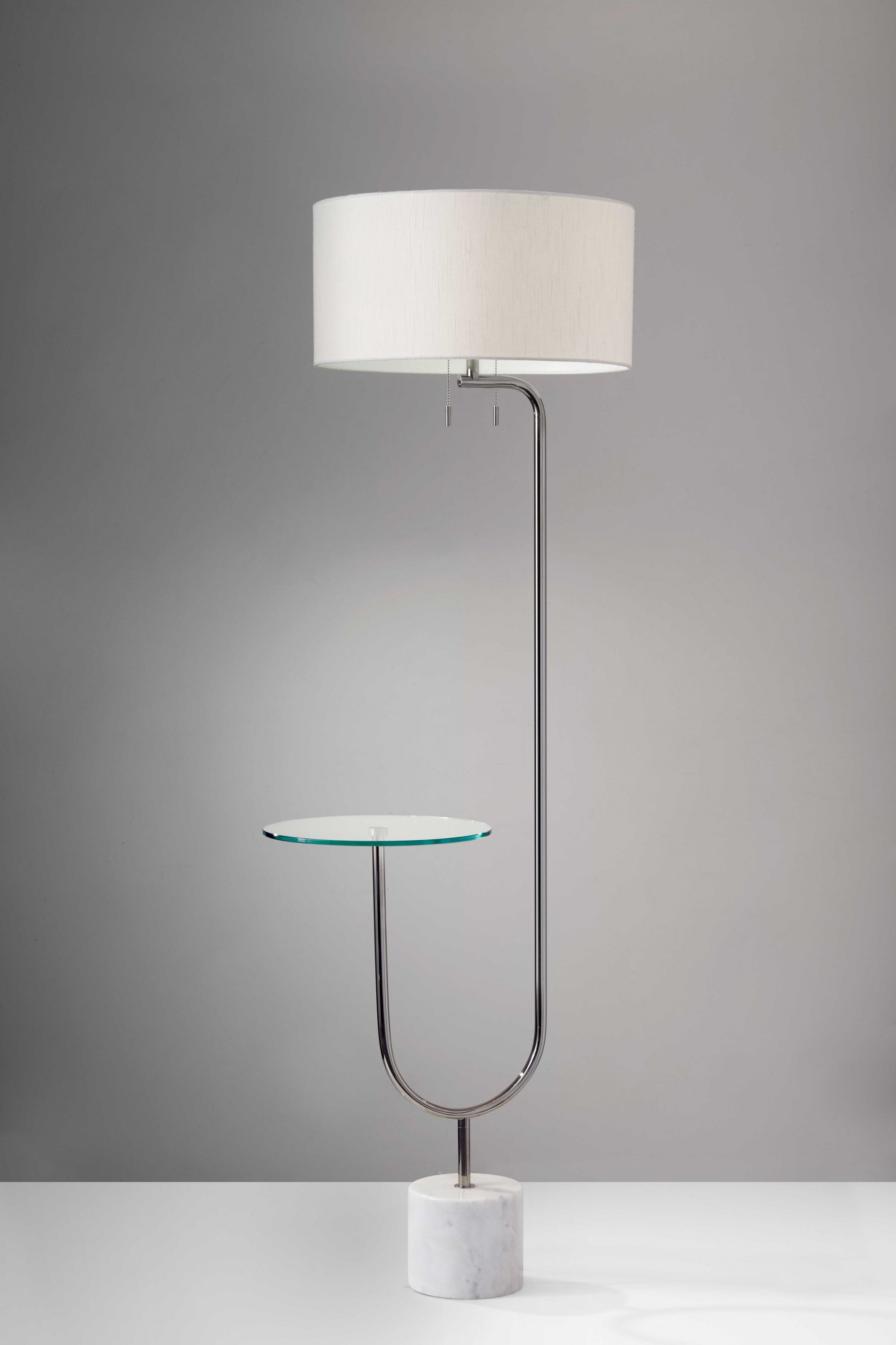 Looped Chrome Floor Lamp featuring a glass cocktail tabletop, textured white fabric shade, and a chunky white marble base, perfect for modern decor.