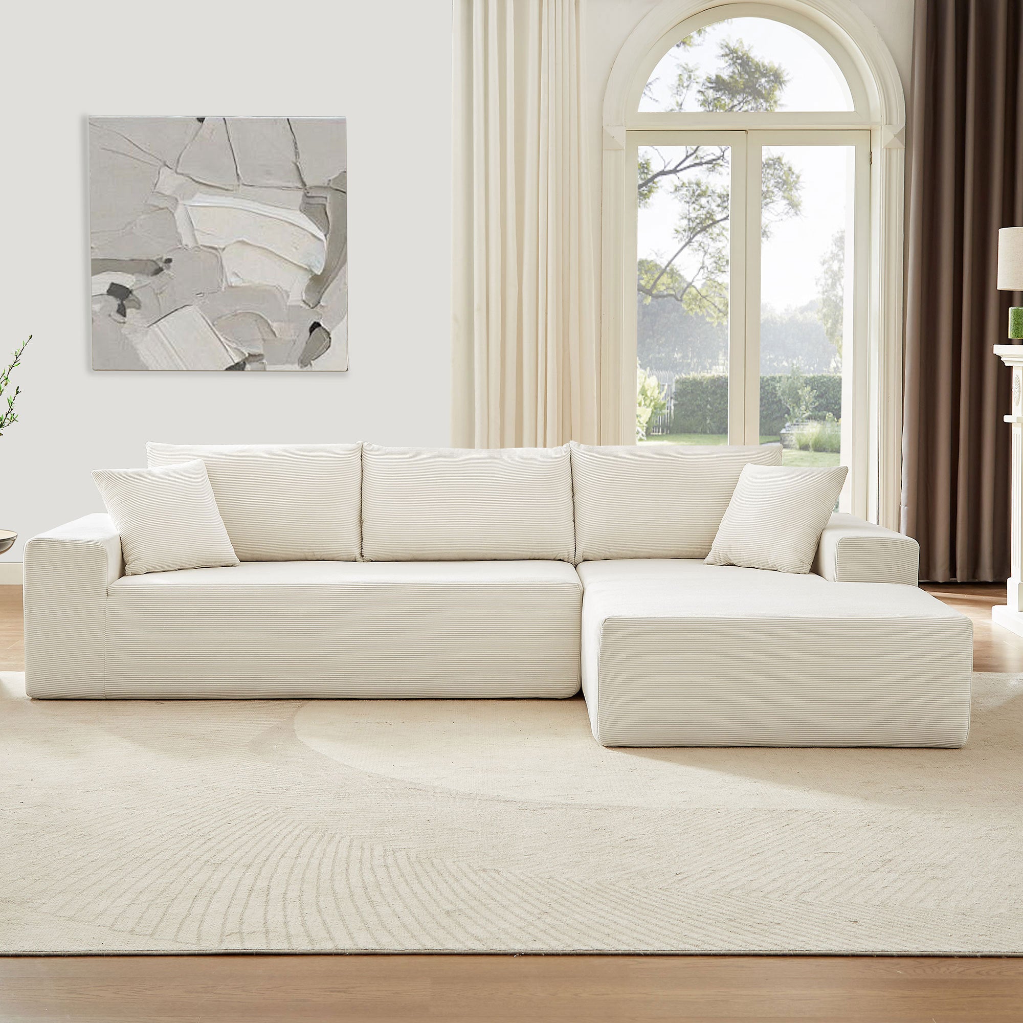 A modern modular sectional living room sofa set in beige upholstery, featuring a chaise lounge and plush cushions, perfect for stylish and comfortable living spaces.