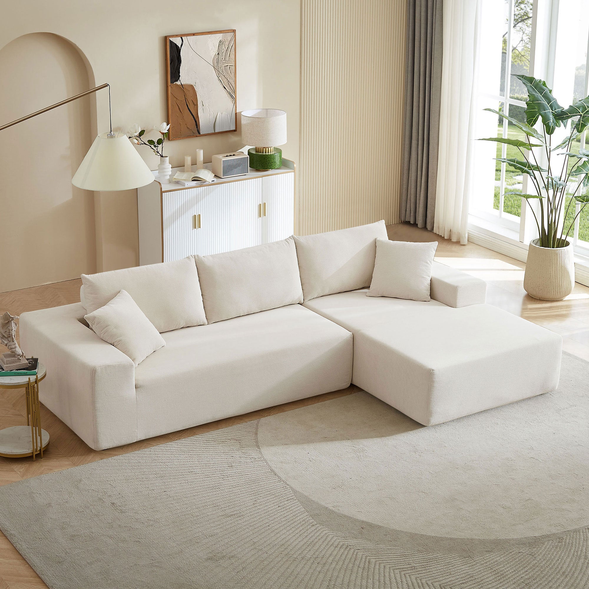 A modern modular sectional living room sofa set in beige upholstery, featuring a chaise lounge and plush cushions, perfect for stylish and comfortable living spaces.