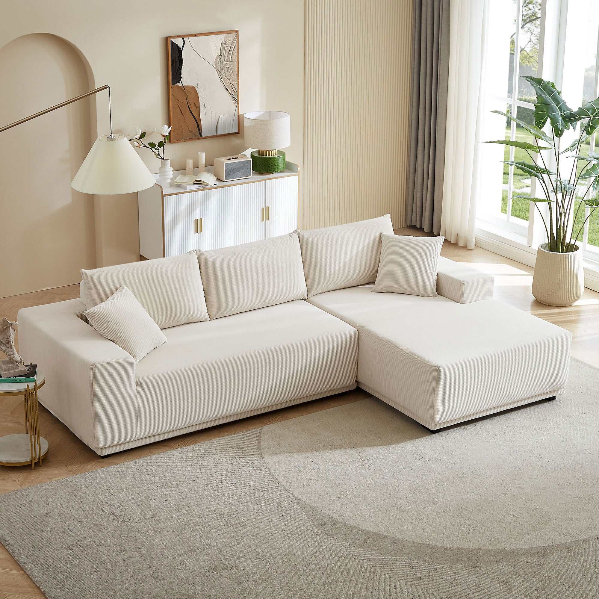 A modern modular sectional living room sofa set in beige upholstery, featuring a chaise lounge and plush cushions, perfect for stylish and comfortable living spaces.