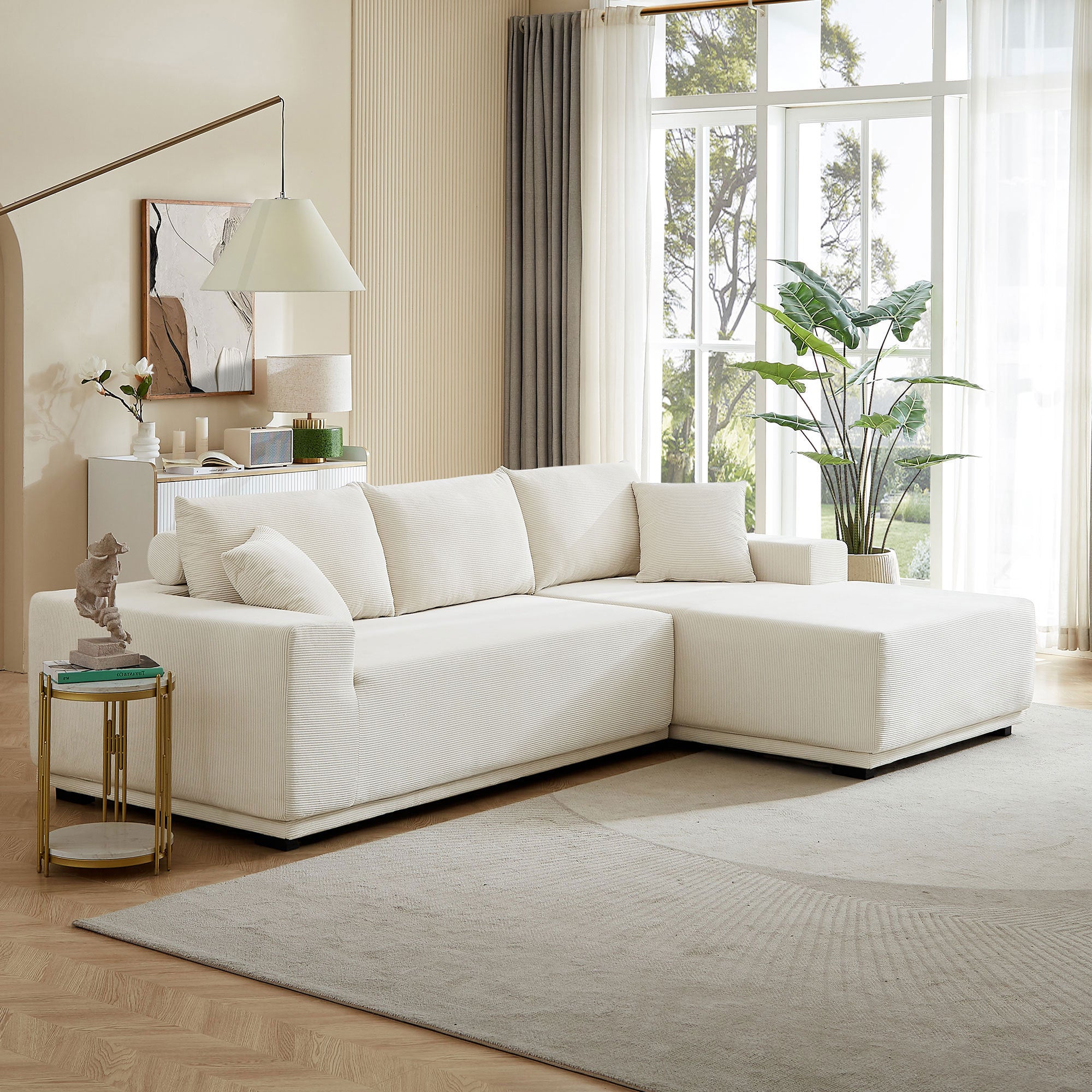 A modern modular sectional living room sofa set in beige upholstery, featuring a chaise lounge and plush cushions, perfect for stylish and comfortable living spaces.