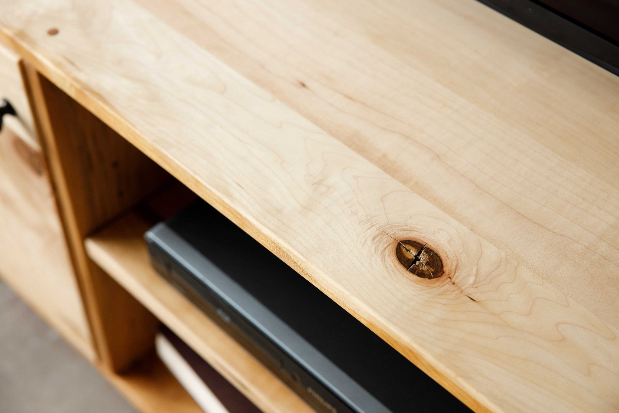 Natural Maple and Black Steel TV Stand showcasing mid-century modern design with spacious storage for media accessories.