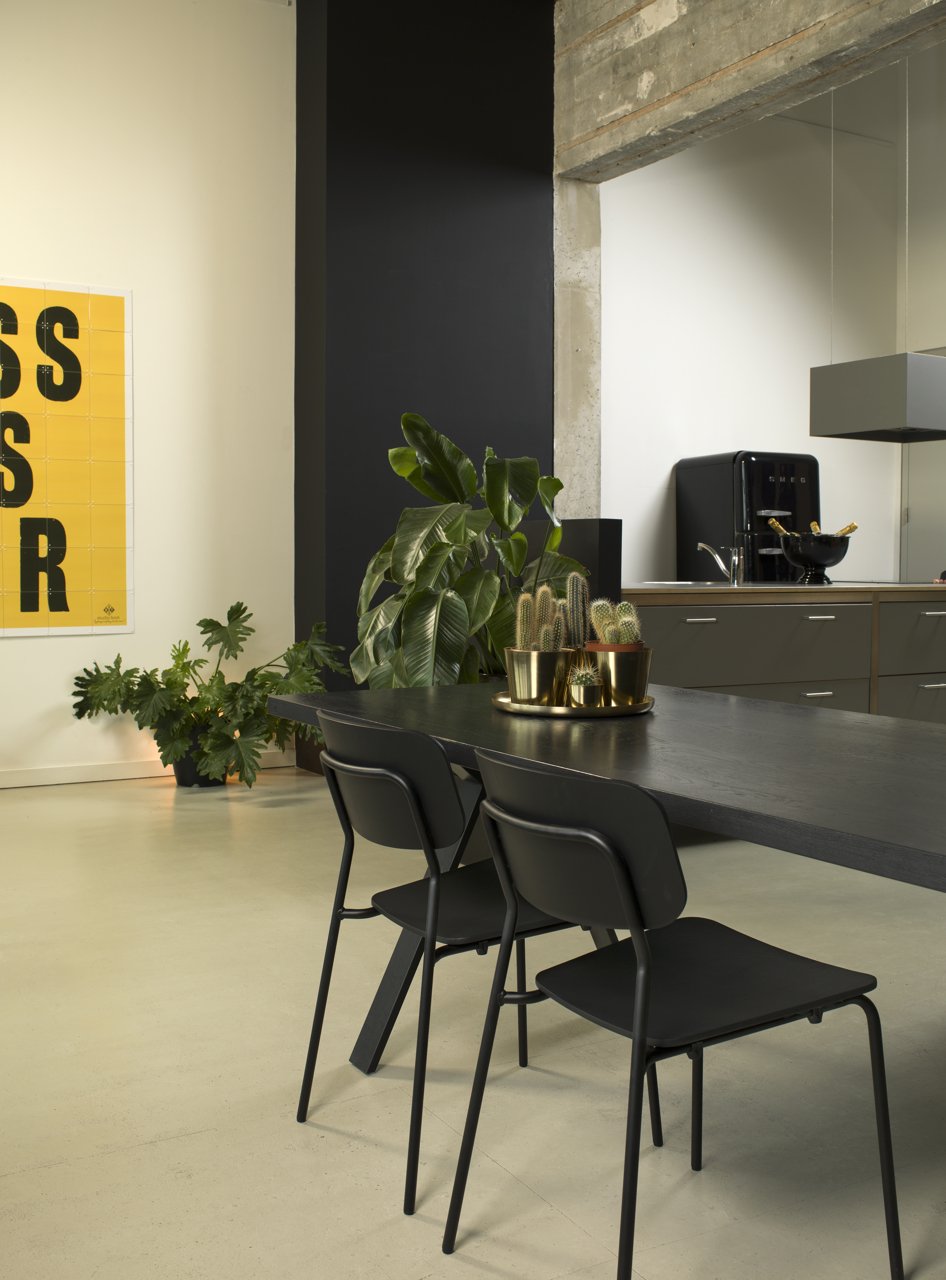 Stylish Oak Black Chair with a sleek black metal frame and lacquered oak seat, perfect for modern interiors.