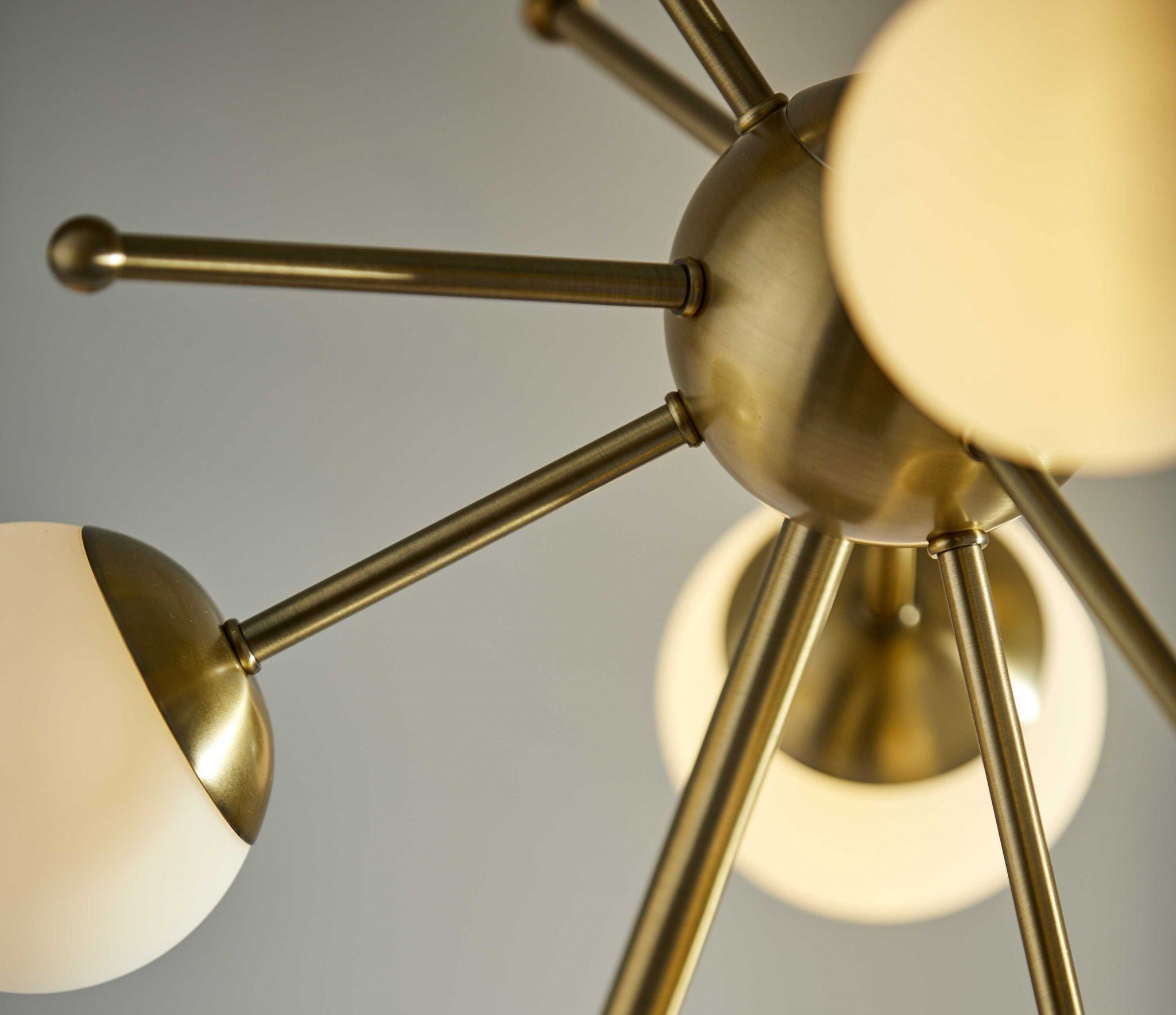 Orbital Sphere Brass LED Table Lamp with six opal glass globes and antique brass finish on a black marble base.