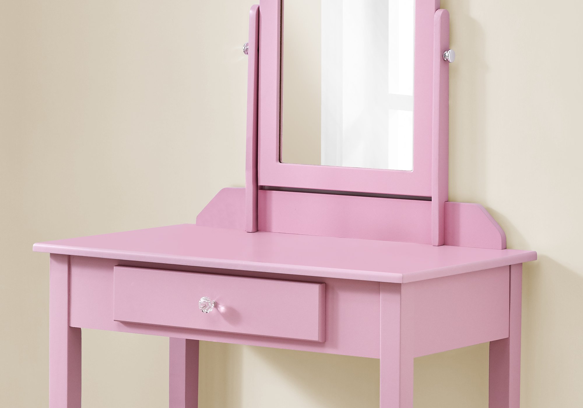 A stylish pink vanity mirror with a storage drawer, featuring a heart cut-out design and a crystal knob, perfect for a girl's bedroom.