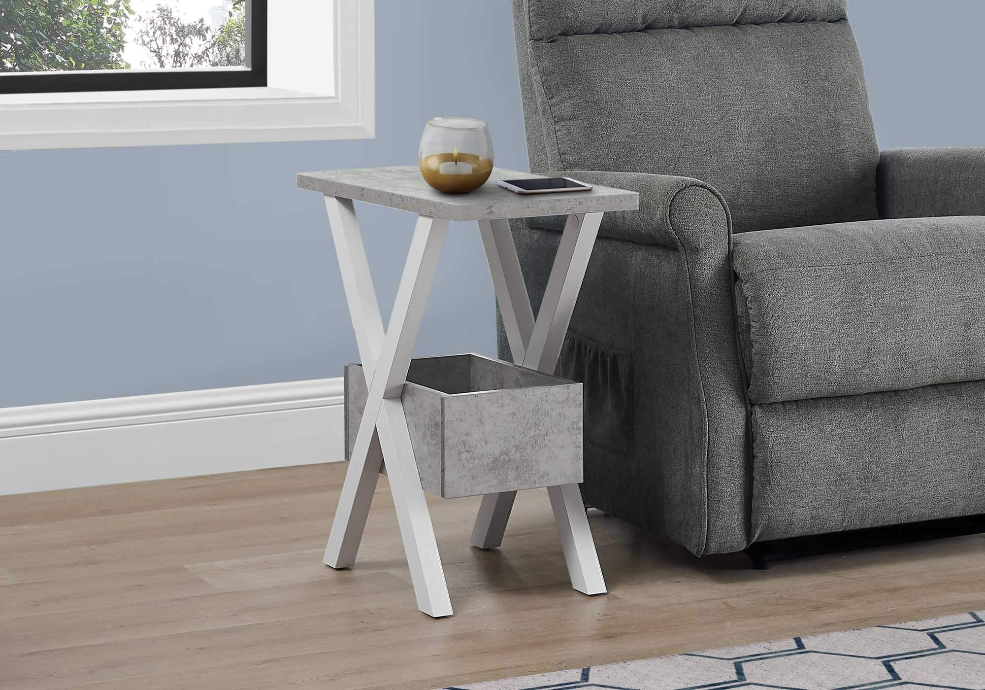 Rectangular accent table with white cross legs and grey cement look finish, perfect for modern decor.