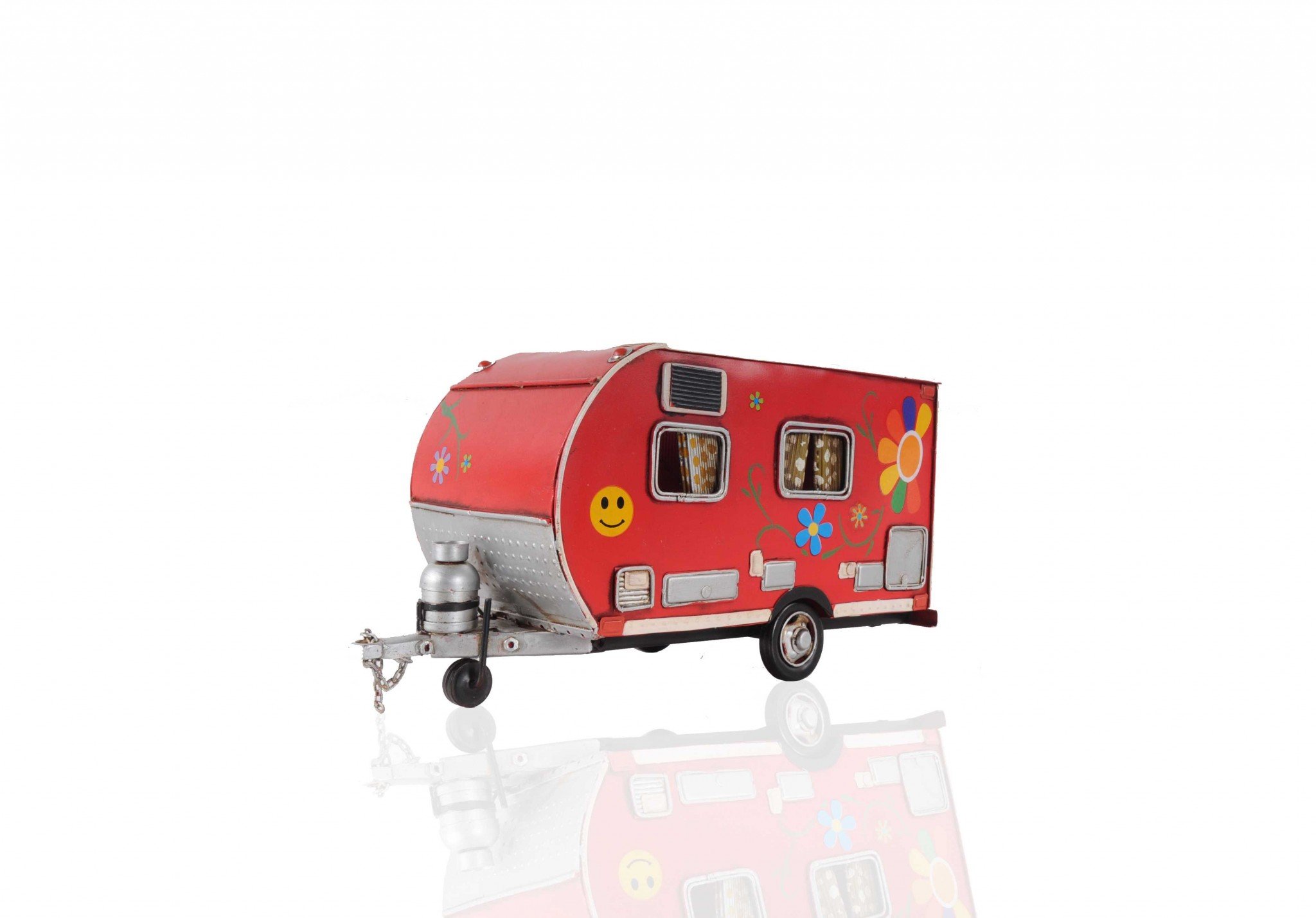 A vibrant red camper trailer tissue holder with floral accents, designed to hold standard tissue boxes, featuring an opening at the back for easy refills.