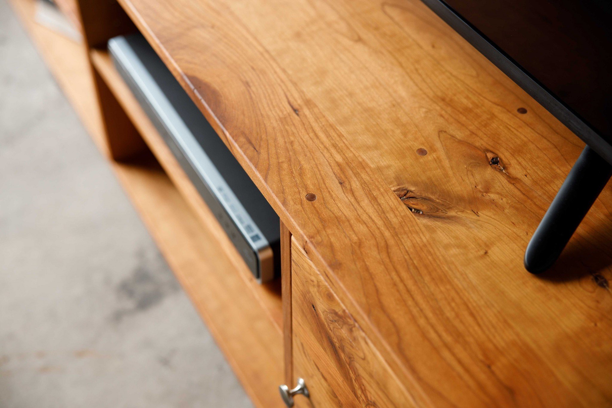 Retro Warm Natural Cherry and Steel TV Stand showcasing mid-century modern design with spacious shelves for media storage.