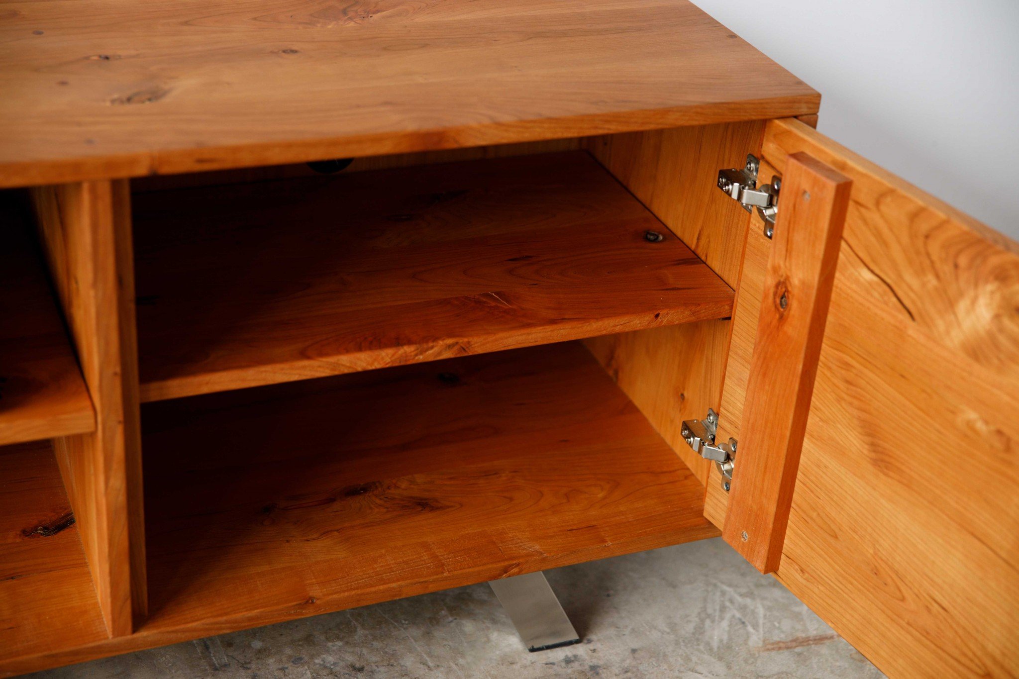 Retro Warm Natural Cherry and Steel TV Stand showcasing mid-century modern design with spacious shelves for media storage.