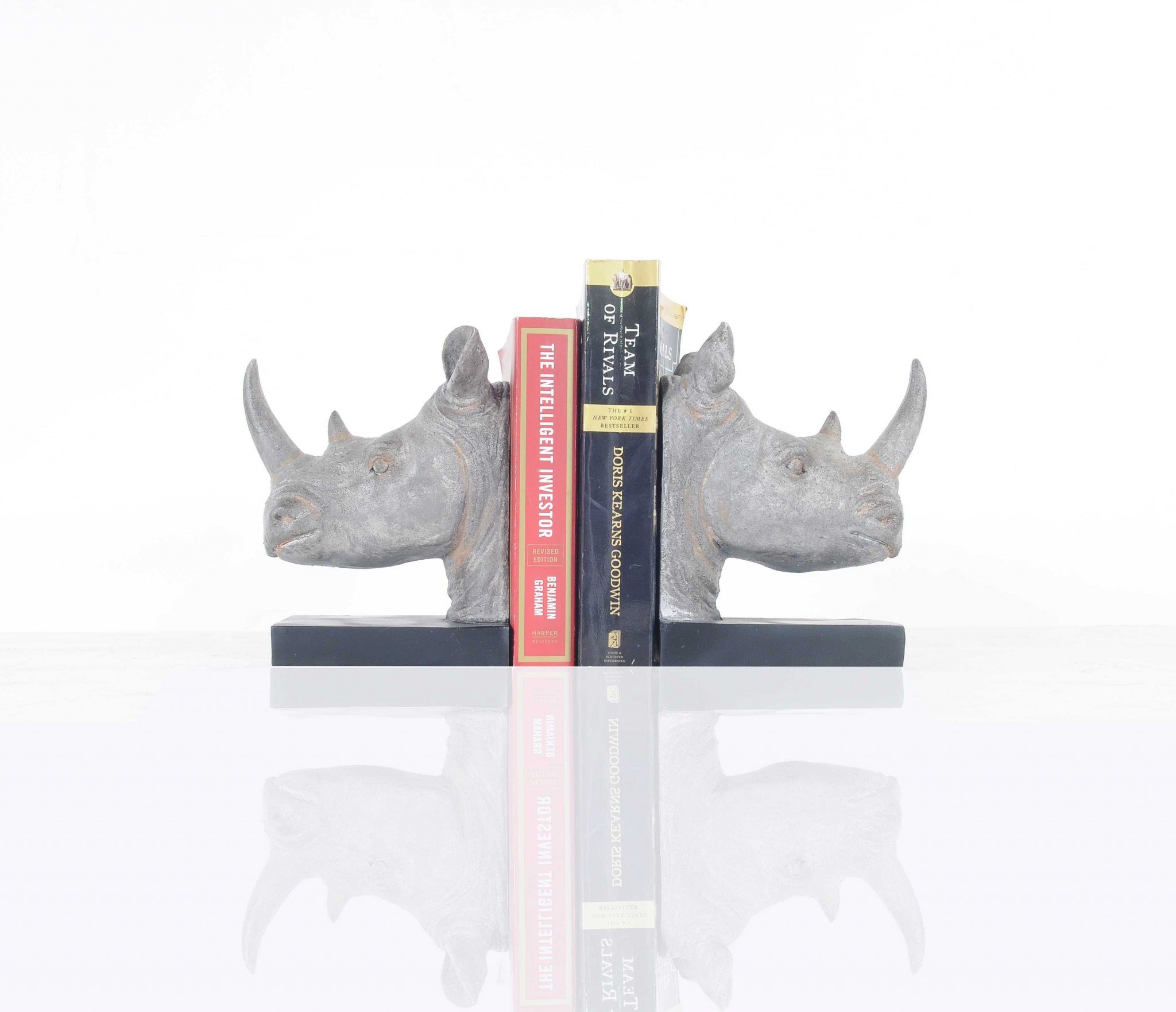 A set of two resin bookends featuring intricately designed rhino heads in dark grey with bronze accents, perfect for holding books upright.