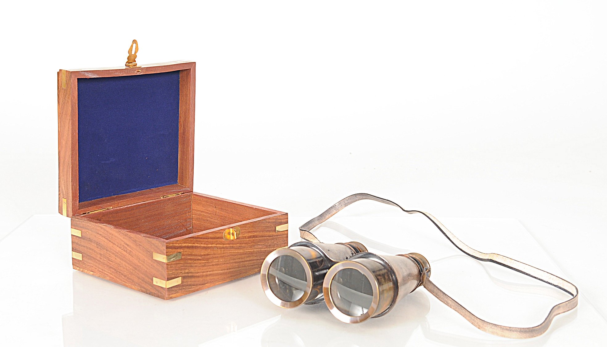 Rustic brass and leather binoculars with a wooden storage box, showcasing antique design and craftsmanship.