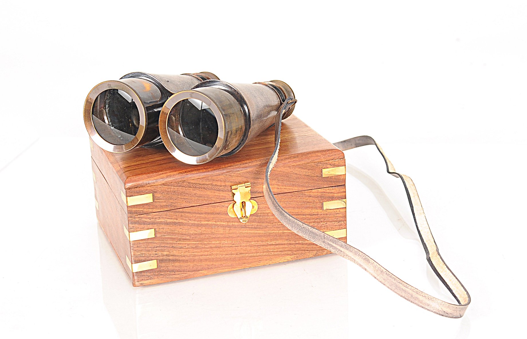 Rustic brass and leather binoculars with a wooden storage box, showcasing antique design and craftsmanship.